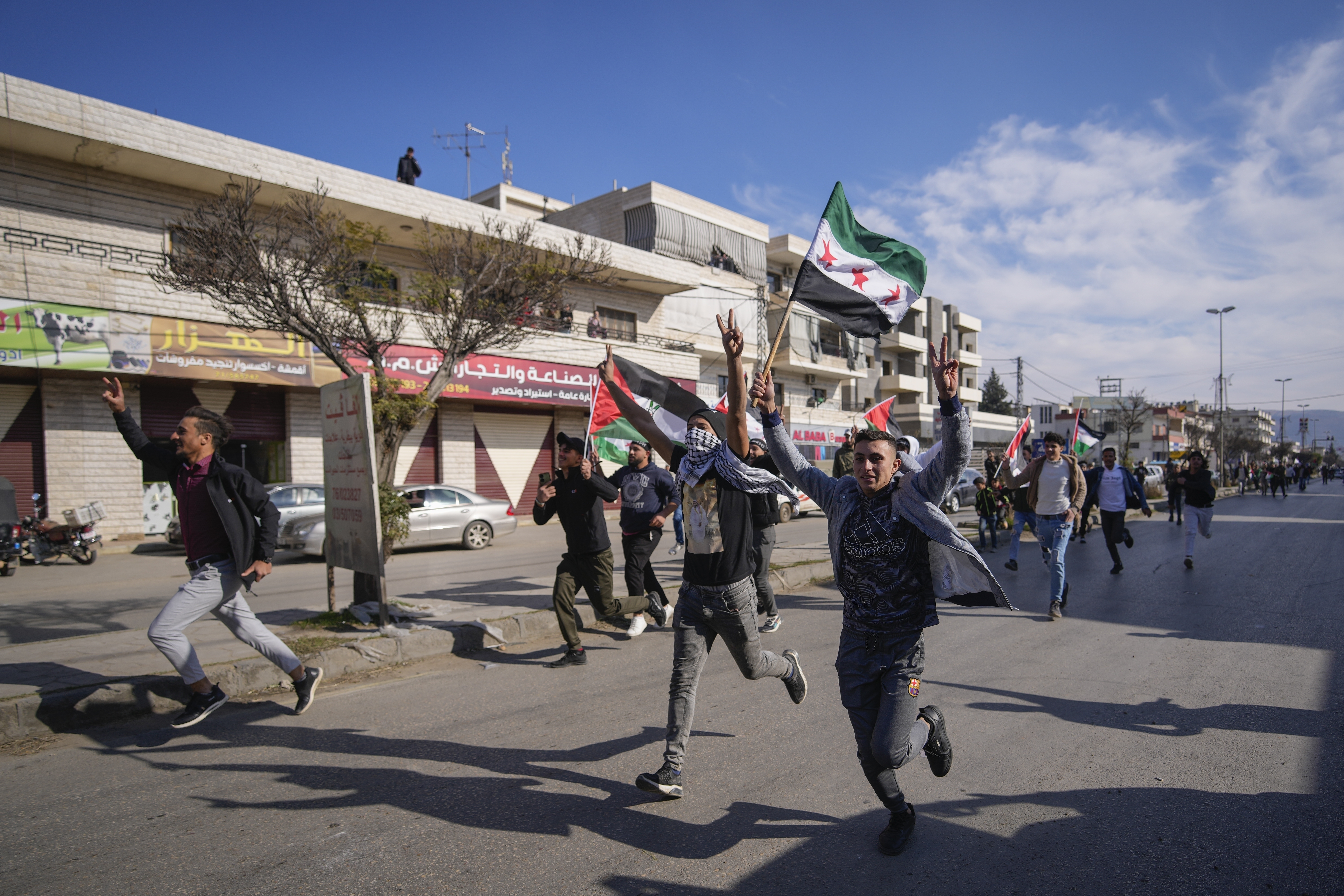 FILE - Syrians celebrate the fall of Bashar Assad's government in the town of Bar Elias, Lebanon, near the border with Syria, Sunday, Dec. 8, 2024. (AP Photo/Hassan Ammar, File)