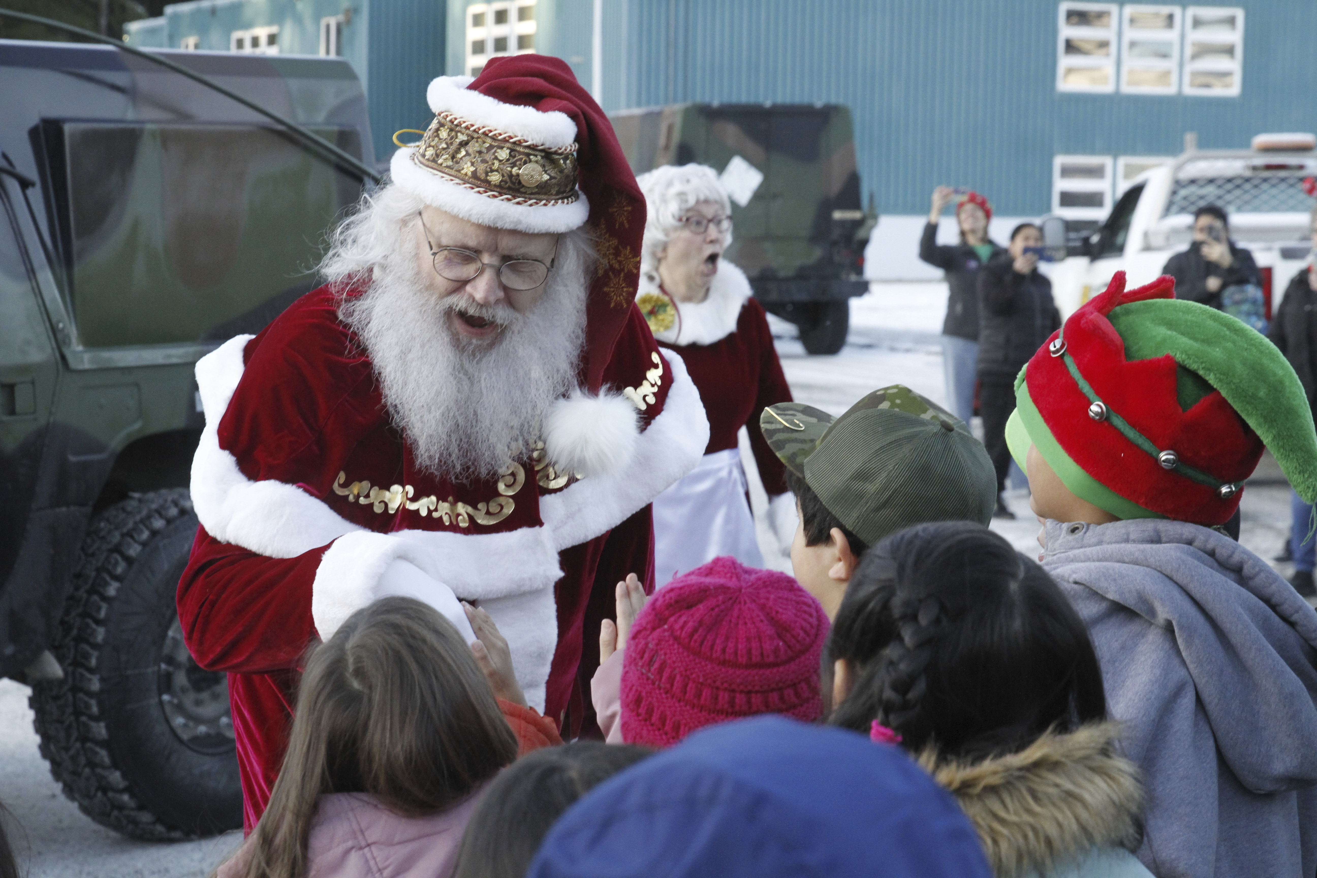 Santa Claus meets children after arriving at the school in Yakutat, Alaska, as part of the Alaska National Guard's Operation Santa initiative that brings Christmas to an Indigenous community that has suffered a hardship, Wednesday, Dec. 18, 2024. (AP Photo/Mark Thiessen).