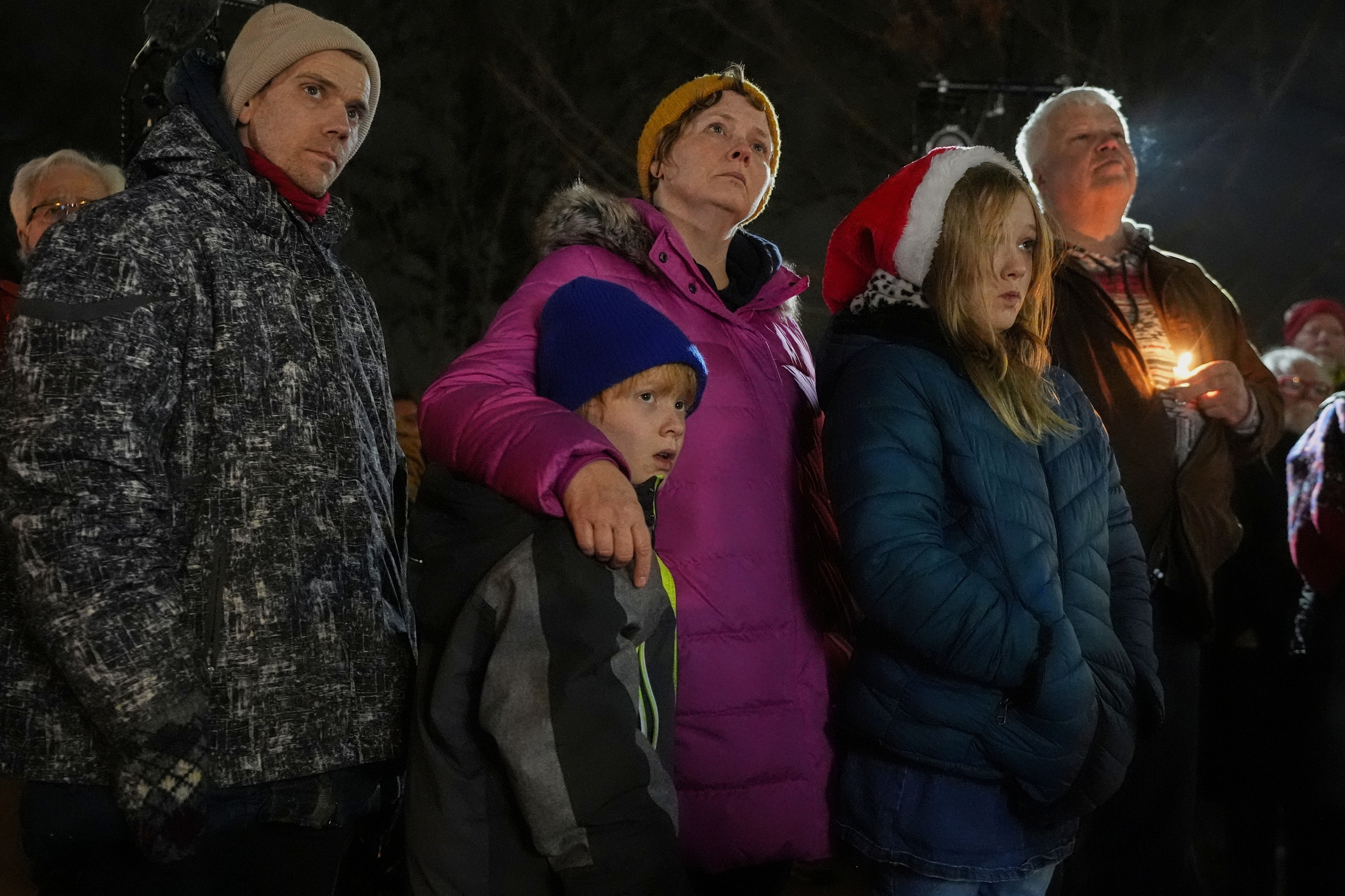 Supporters hold candles during a candlelight vigil Tuesday, Dec. 17, 2024, outside the Wisconsin Capitol in Madison, Wis., following a shooting at the Abundant Life Christian School on Monday, Dec. 16. (AP Photo/Morry Gash)