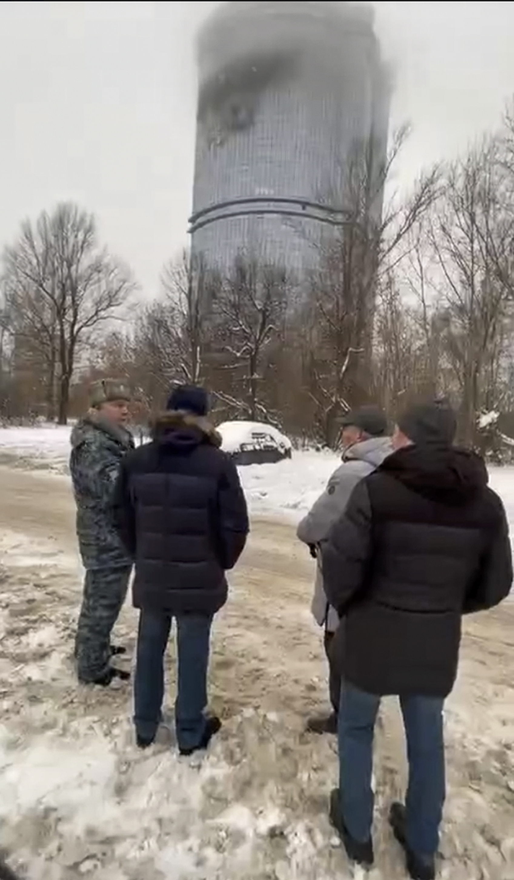 In this photo released Saturday, Dec. 21, 2024, by the official Telegram channel of the Kazan City Hall, local officials look at a damage site at the residential complex called "Lazurnye Nebesa," or Azure Skies, in Kazan, Russia, following Ukrainian drone attacks. (Official Telegram channel of the Kazan City Hall via AP)