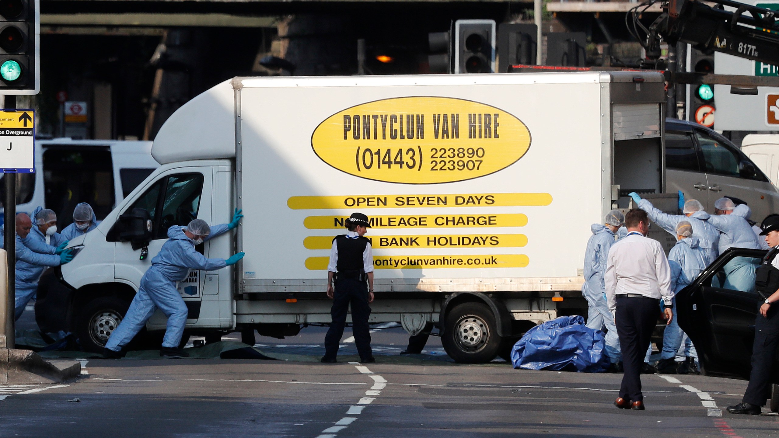 FILE - Forensic officers move the van at Finsbury Park in north London, where a vehicle struck pedestrians in north London Monday, June 19, 2017. (AP Photo/Frank Augstein, File)