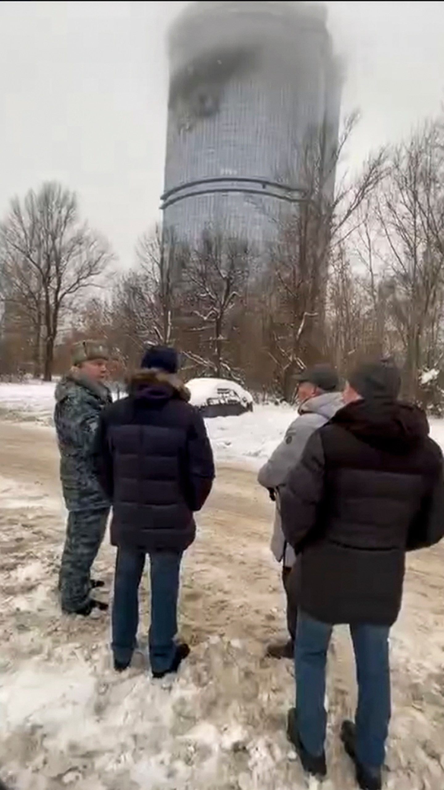 In this photo released Saturday, Dec. 21, 2024, by the official Telegram channel of the Kazan City Hall, local officials look at a damage site at the residential complex called "Lazurnye Nebesa," or Azure Skies, in Kazan, Russia, following Ukrainian drone attacks. (Official Telegram channel of the Kazan City Hall via AP)