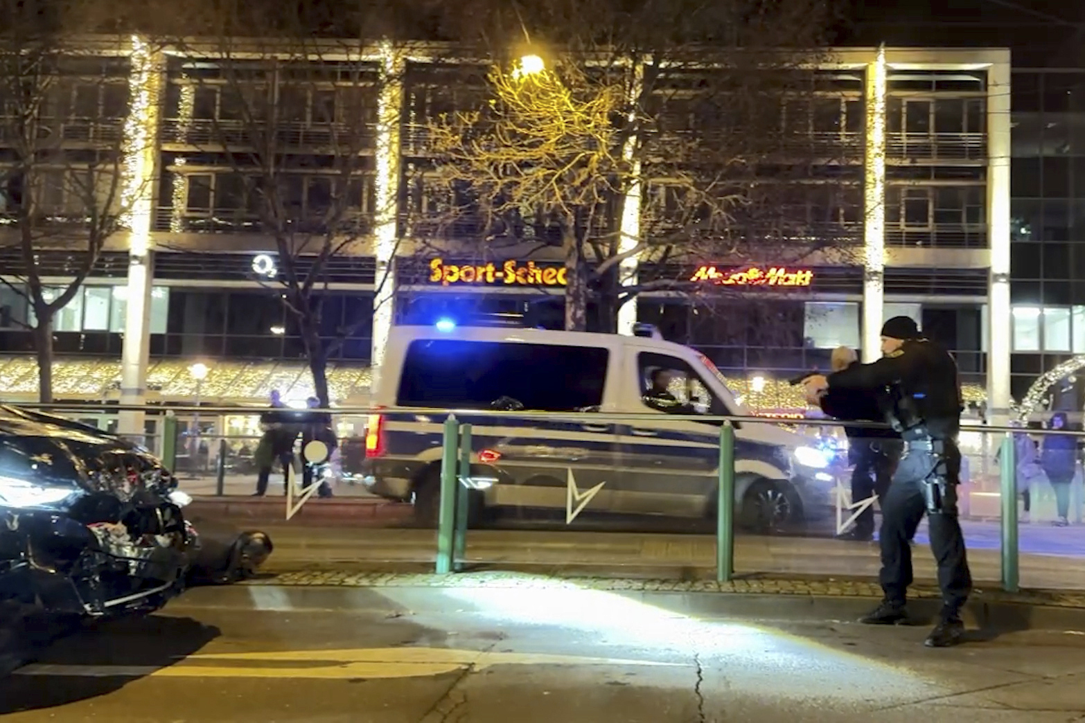 An image taken from a video shows police officers arresting a suspect after car drove into a crowd at the Christmas market in Magdeburg, Germany, Friday Dec. 20, 2024. (TNN/DPA via AP)