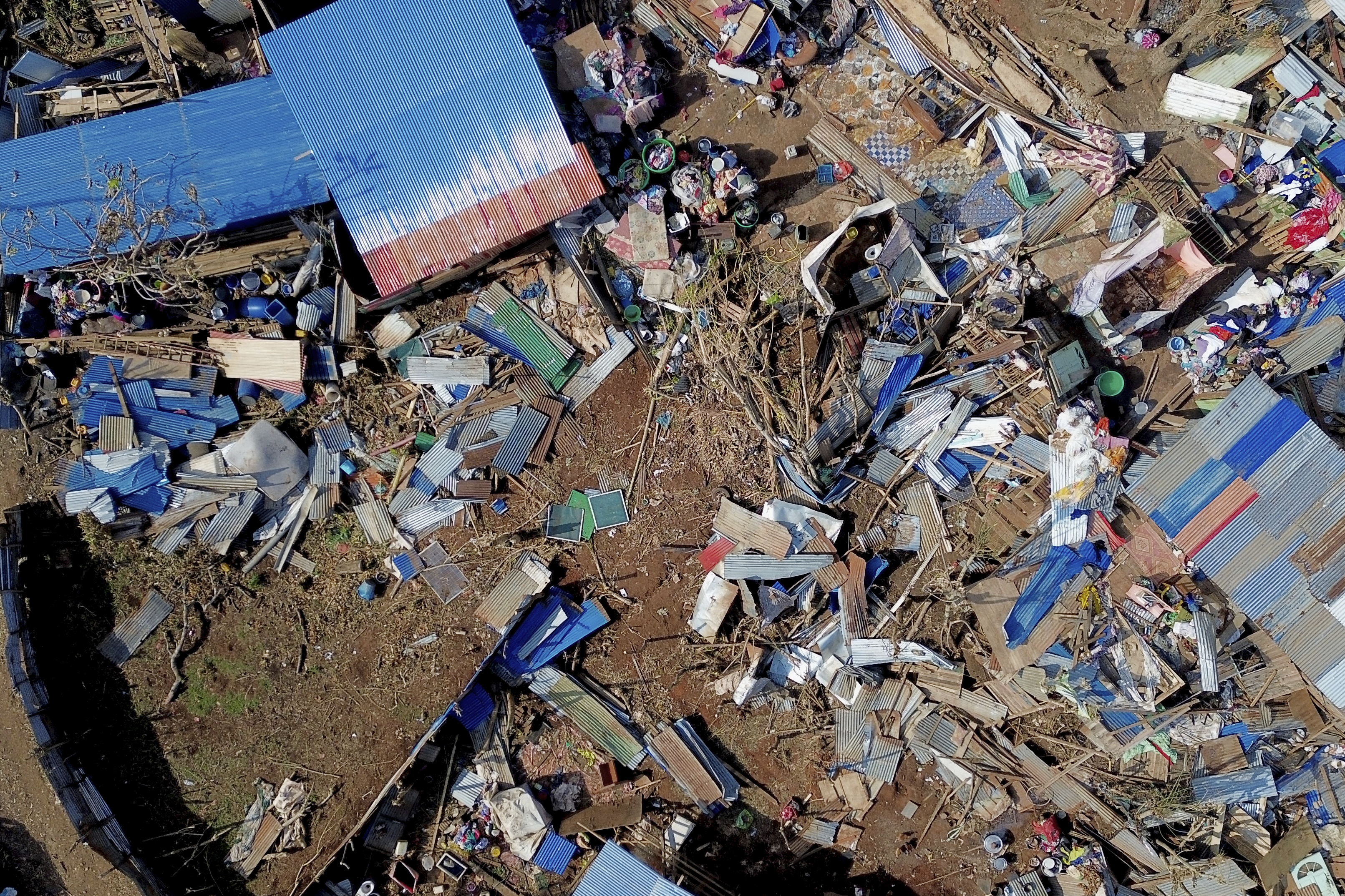 This aerial view shows destroyed homes in the Barakani, Mayotte, informal settlement, Saturday, Dec. 21, 2024. (AP Photo/Adrienne Surprenant)