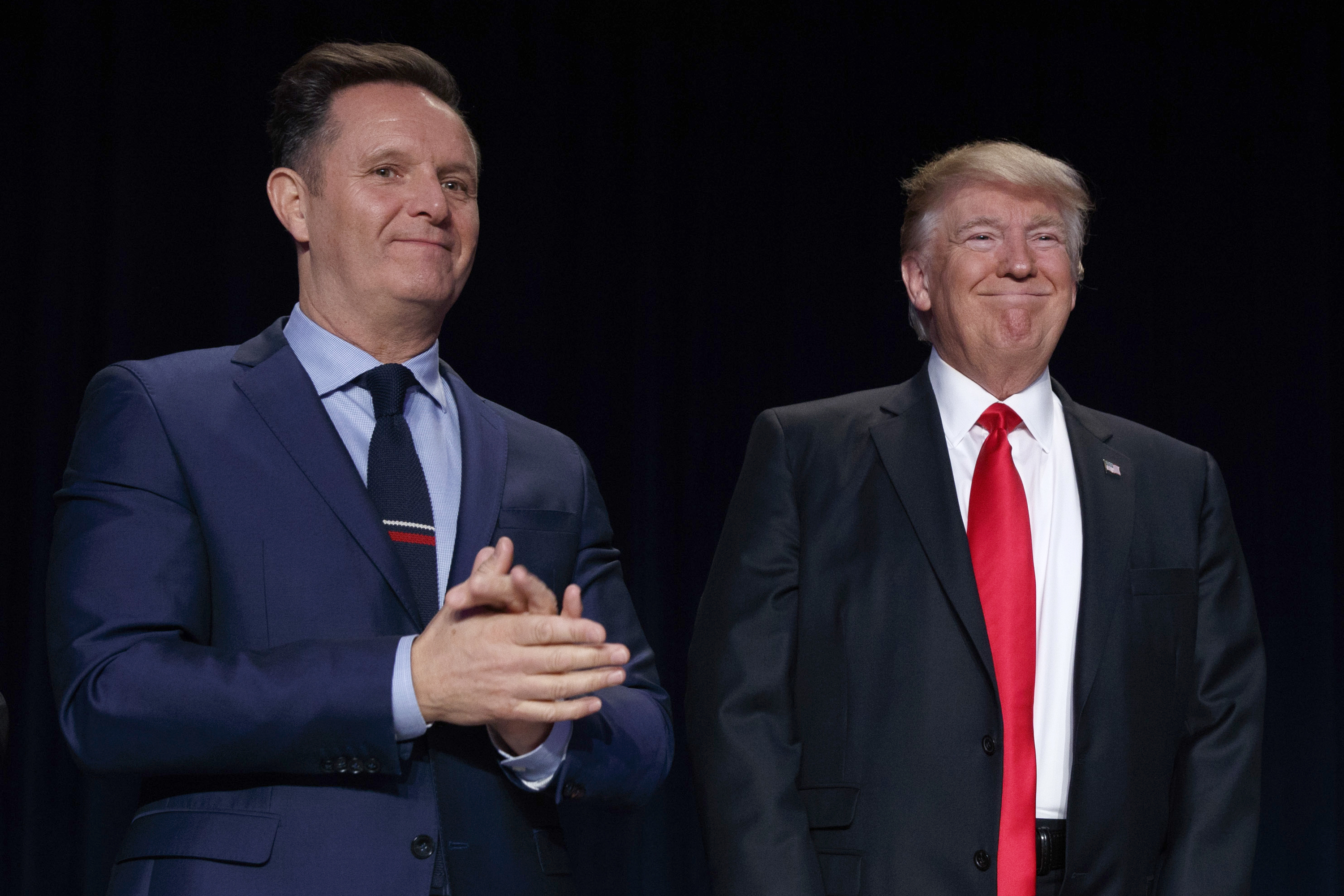 FILE - Television producer Mark Burnett, left, looks on as President Donald Trump arrives for the National Prayer Breakfast, Feb. 2, 2017, in Washington. (AP Photo/Evan Vucci, File)