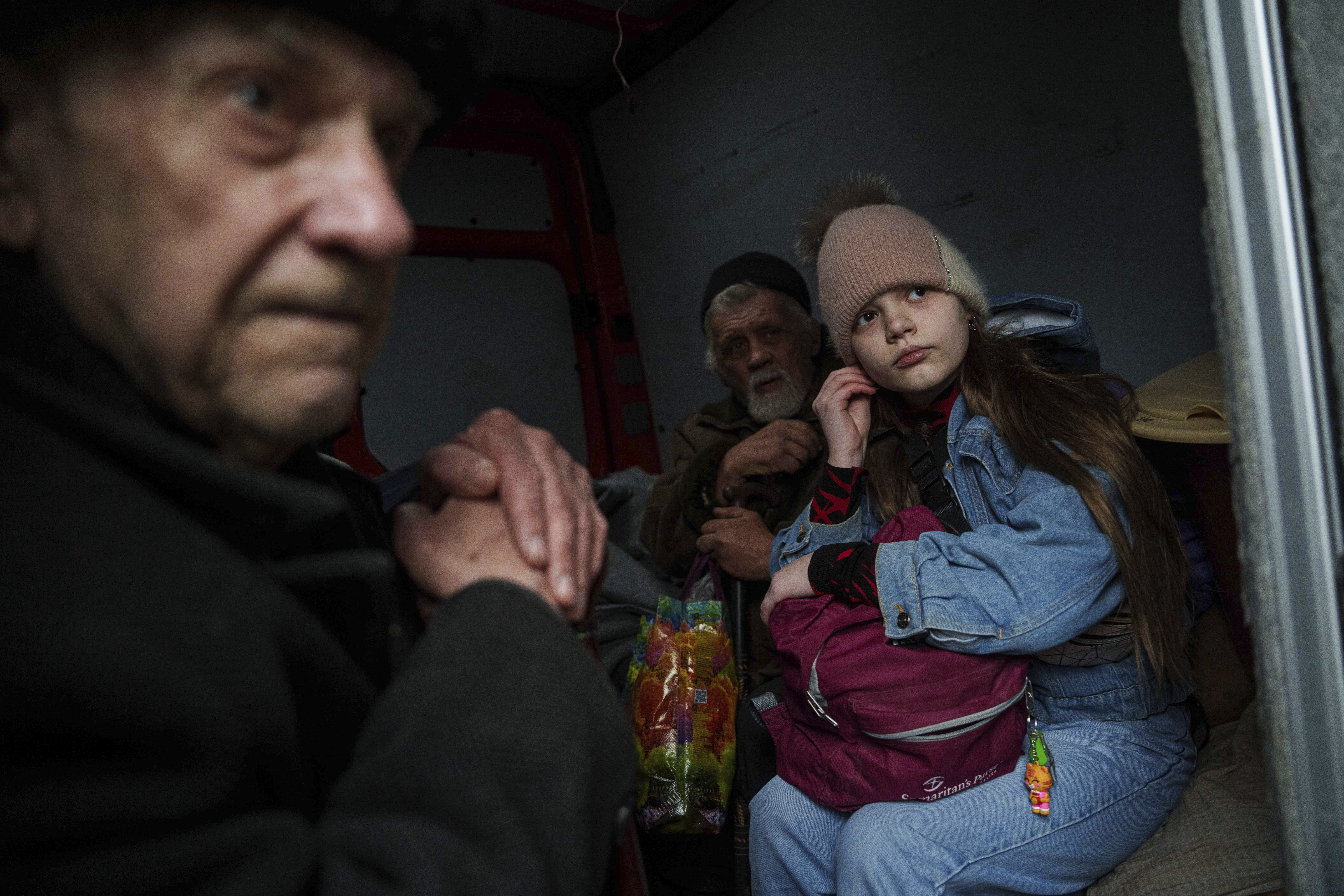 Hanna, 12, and her family sit ride inside a van during an evacuation from Pokrovsk, Ukraine, Saturday, Dec. 21, 2024. (AP Photo/Evgeniy Maloletka)