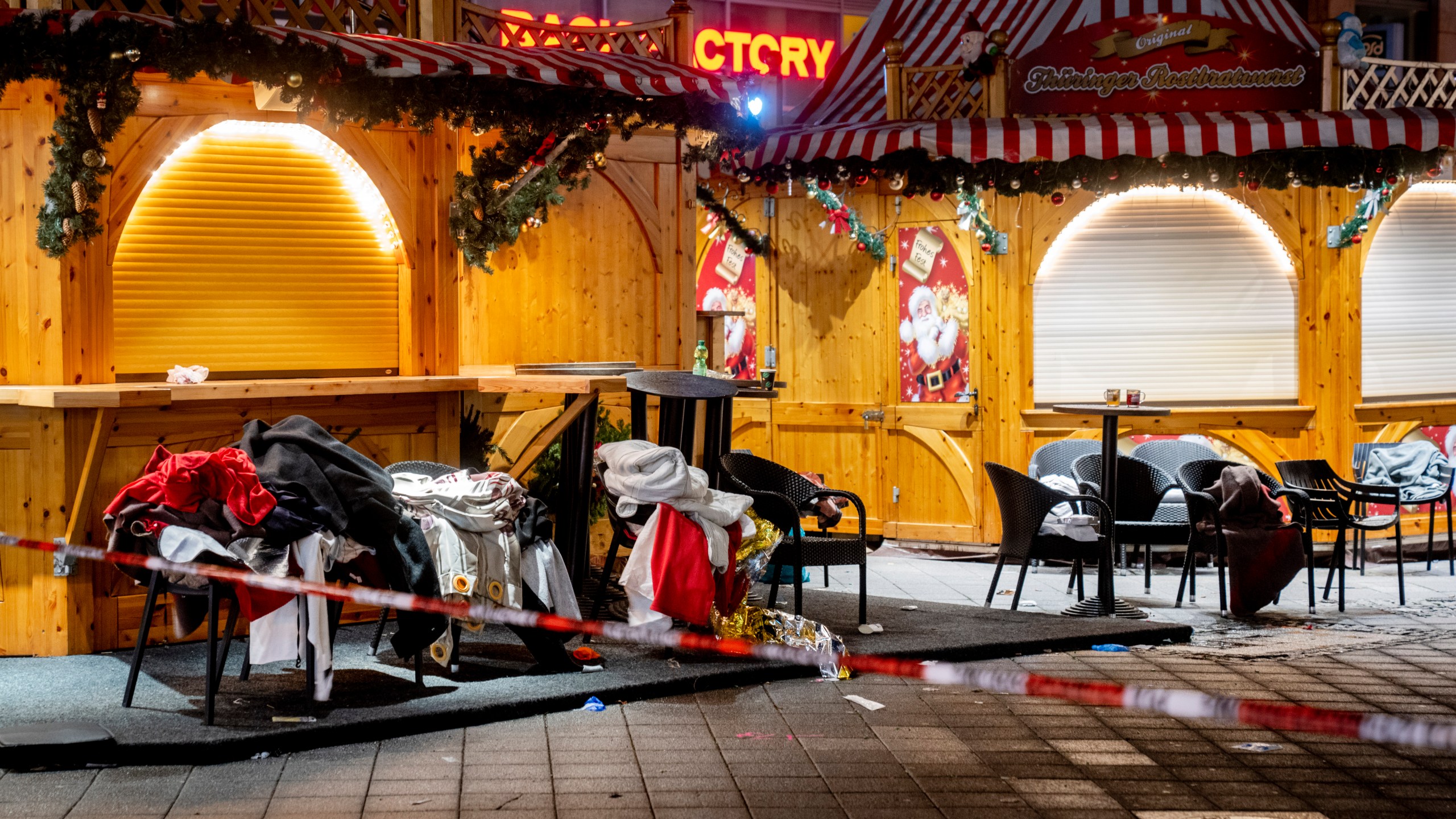 Clothes and blankets lie on chairs at the Christmas market, where a car drove into a crowd on Friday evening, in Magdeburg, Germany, Sunday, Dec. 22, 2024. (AP Photo/Michael Probst)