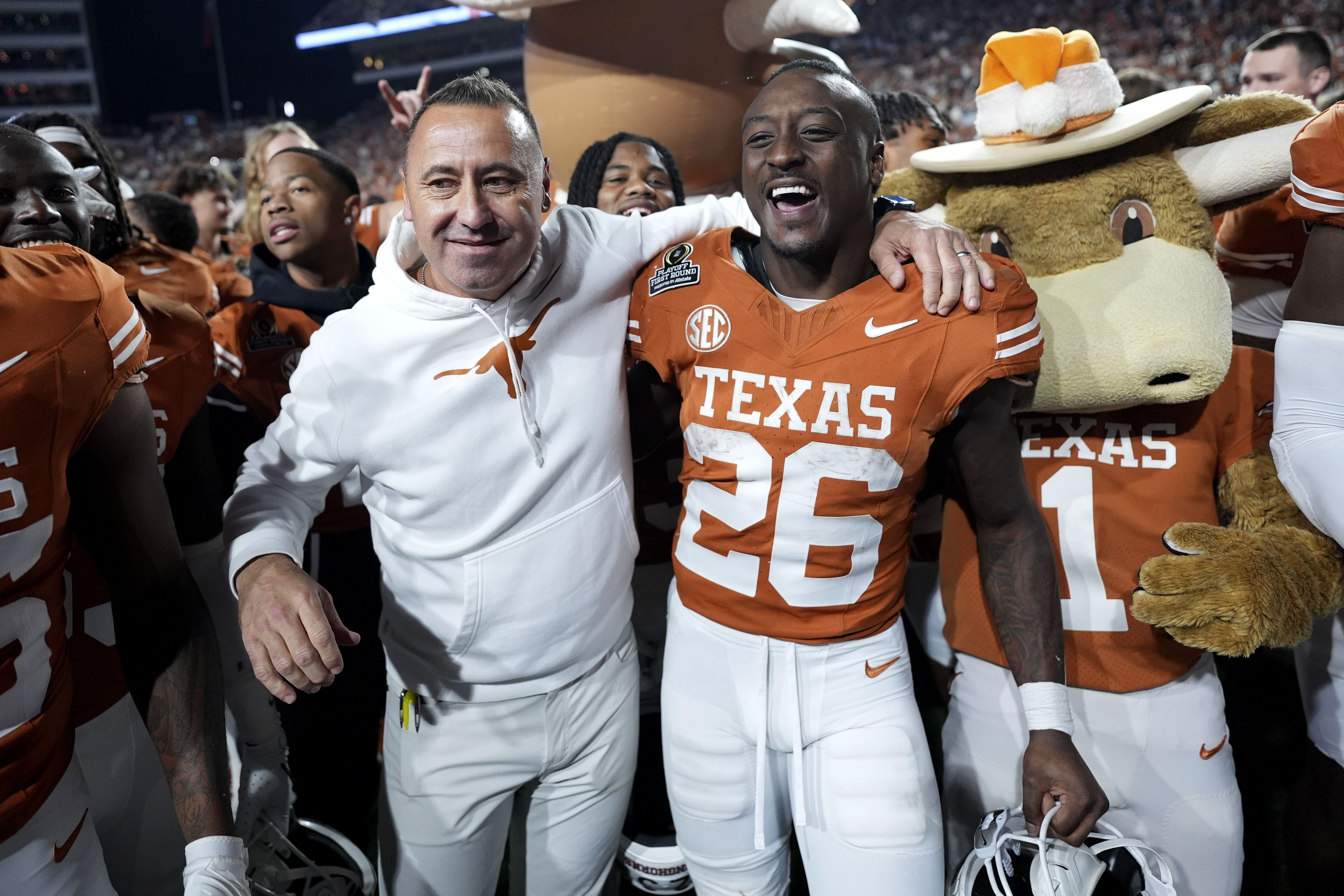 Texas head coach Steve Sarkisian celebrates with running back Quintrevion Wisner (26) after a first round game against Clemson in the College Football Playoff, Saturday, Dec. 21, 2024, in Austin, Texas. (AP Photo/Eric Gay)