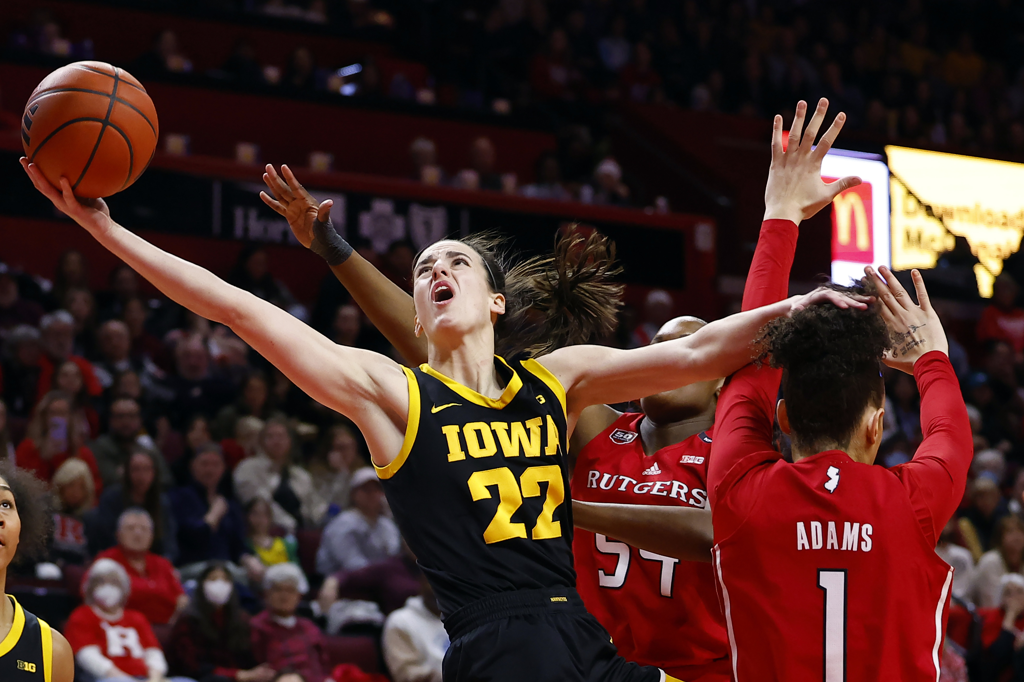 FILE - Iowa guard Caitlin Clark (22) drives to the basket past Rutgers guard Destiny Adams (1) during the first half of an NCAA college basketball game Friday, Jan. 5, 2024, in Piscataway, N.J. (AP Photo/Noah K. Murray, File)