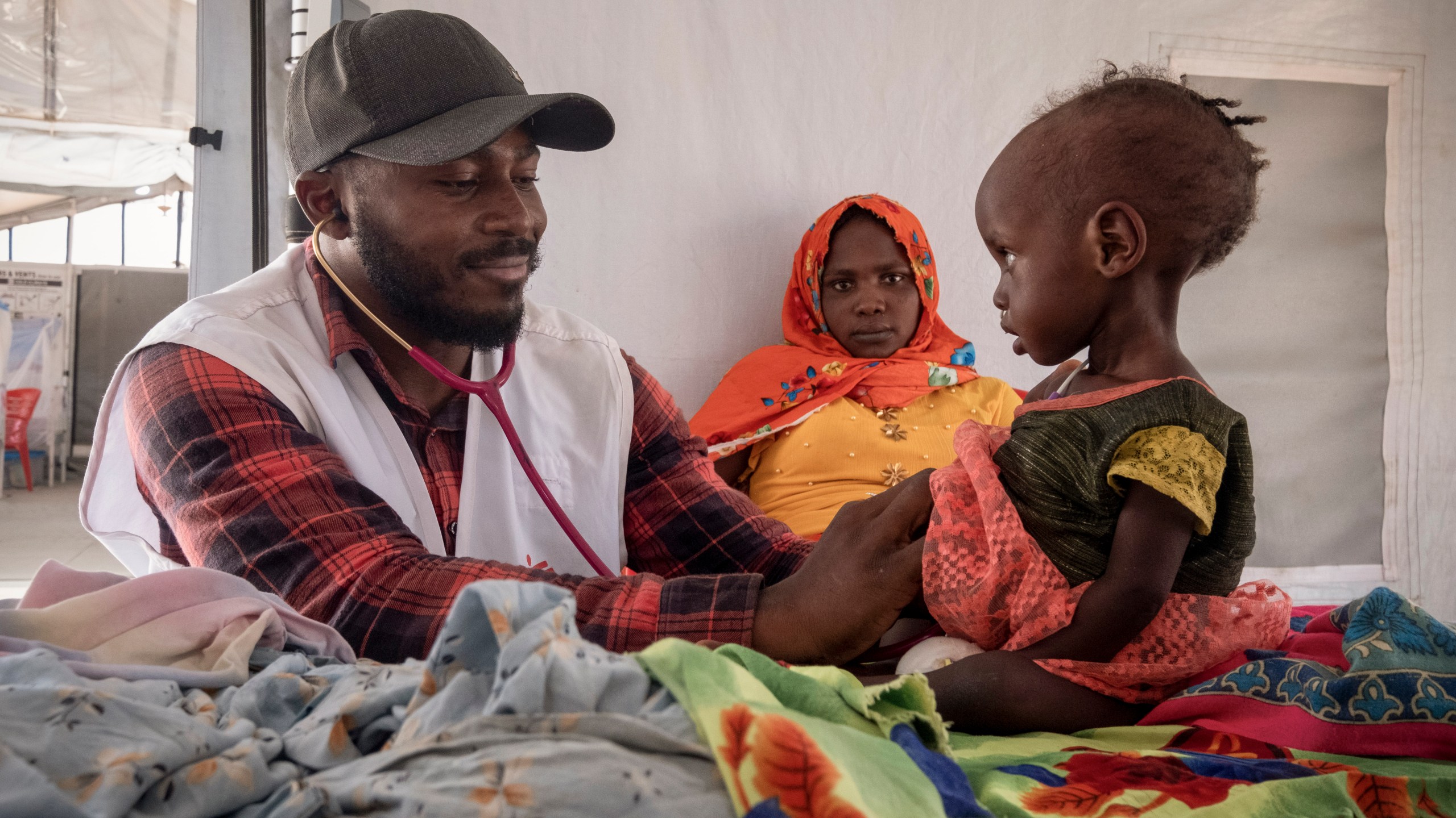 FILE - A doctor treats a Sudanese child suffering from malnutrition are treated at an MSF clinic in Metche Camp, Chad, near the Sudanese border, on April 6, 2024. (AP Photo/Patricia Simon, File)