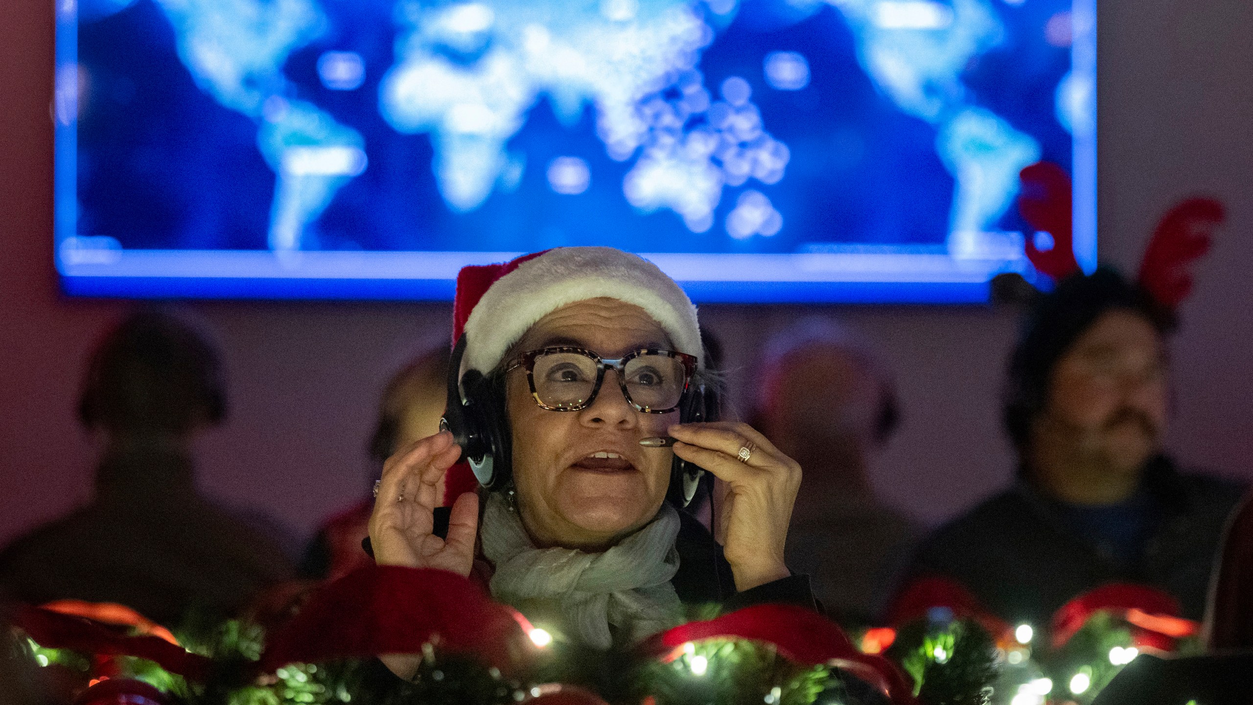 Volunteers answer phone calls from around the world Tuesday, Dec. 24, 2024, at the NORAD Tracks Santa center at Peterson Space Force Base in Colorado Springs, Colo. (Christian Murdock /The Gazette via AP)