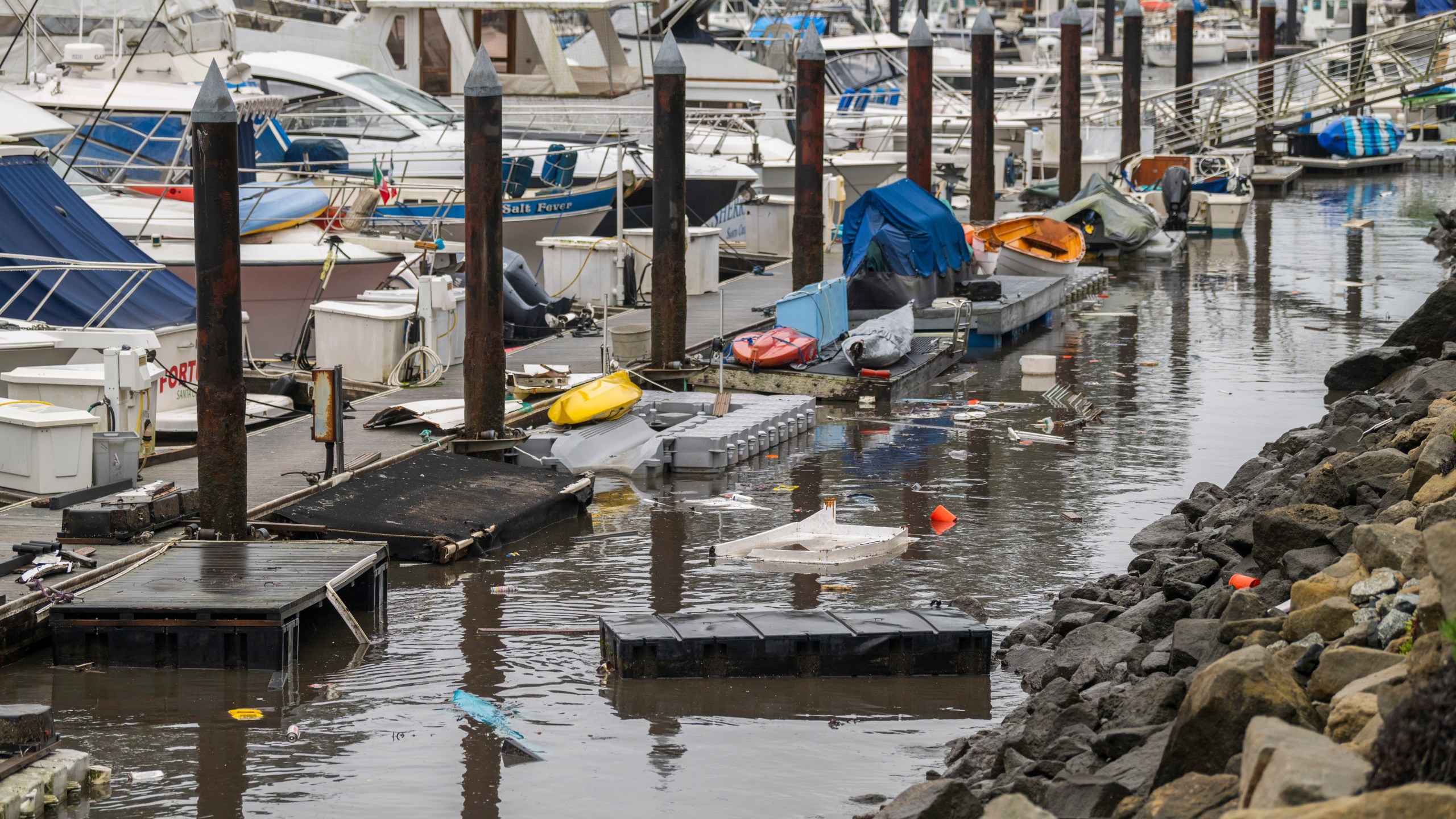 Trash and damaged boat parts float through Santa Cruz Harbor in Santa Cruz, Calif., Tuesday, Dec. 24, 2024. (AP Photo/Nic Coury)