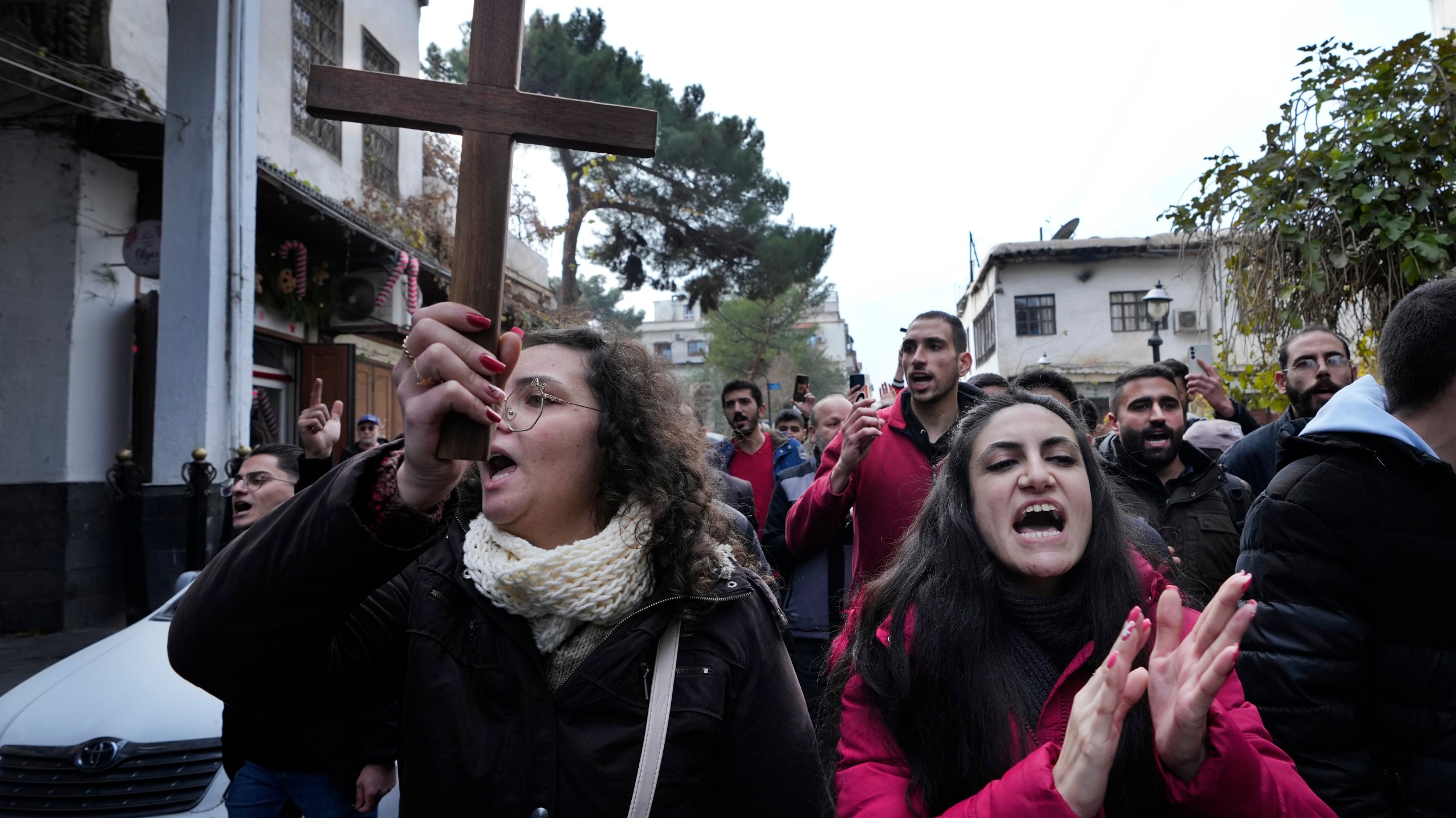 Syrian Christians shout slogans in Damascus, Syria, Tuesday, Dec. 24, 2024, as they march during a protest after a Christmas tree was set on fire in Hamah city on Sunday. (AP Photo/Hussein Malla)