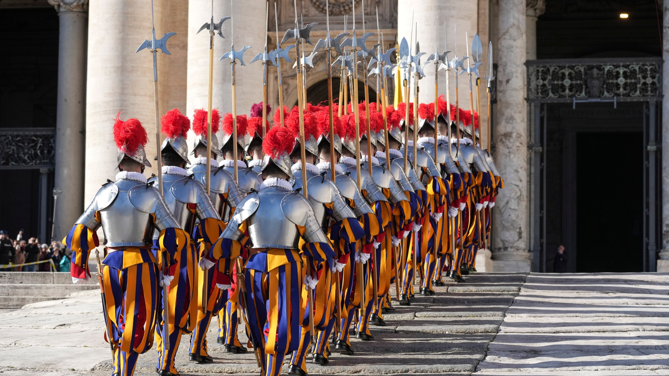 Swiss Guards march in front of St. Peter's Basilica at the Vatican, Wednesday, Dec. 25, 2024. (AP Photo/Andrew Medichini)