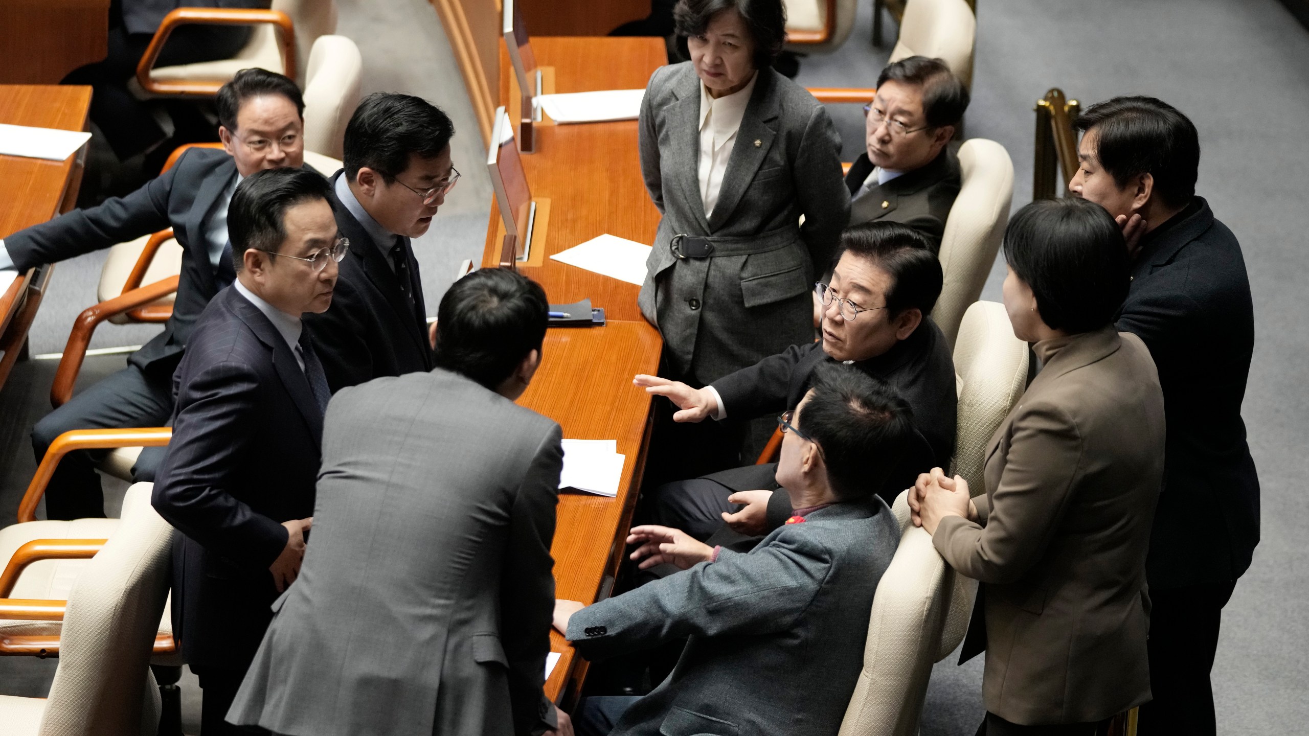 South Korea's main opposition Democratic Party leader Lee Jae-myung, third from right, talks with his party members during the plenary session at the National Assembly in Seoul, South Korea, Thursday, Dec. 26, 2024. (AP Photo/Ahn Young-joon)