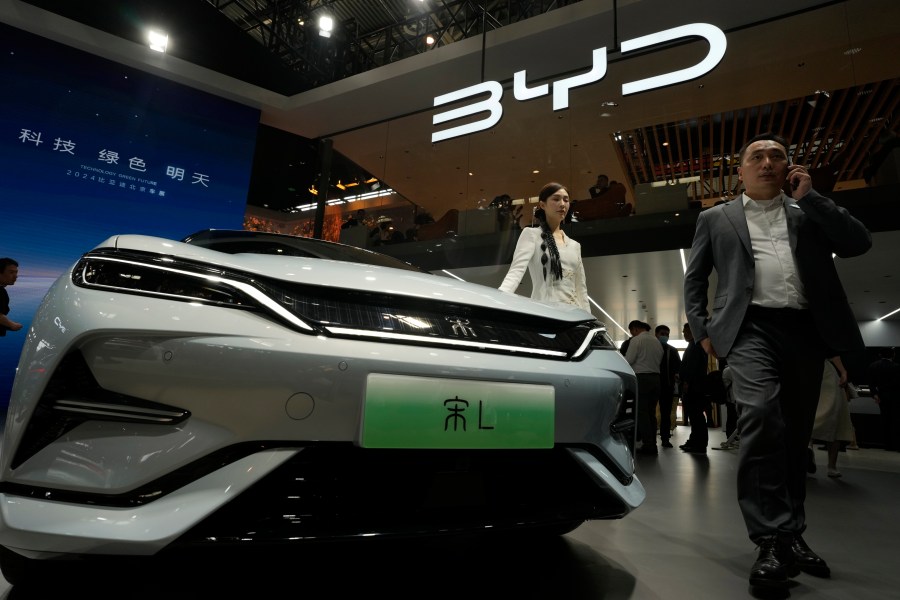 FILE - A model poses near the BYD Song L EV car during Auto China 2024 held in Beijing, April 25, 2024. (AP Photo/Ng Han Guan, File)