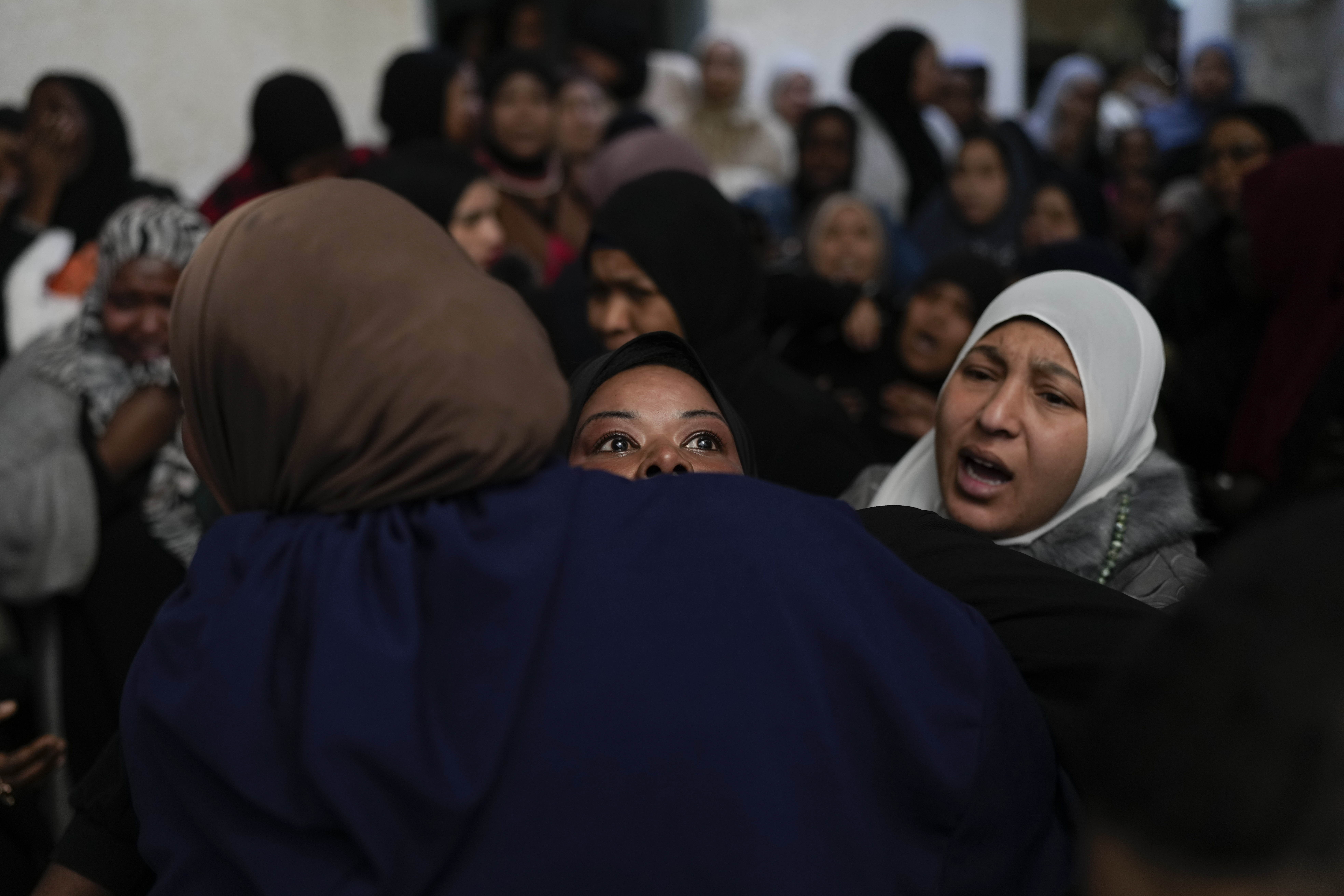 A mourner cries after taking a last look at the body of a relative, one of eight Palestinians killed, during their funeral following the withdrawal of the Israeli army, in the West Bank city of Tulkarem, Thursday, Dec. 26, 2024. (AP Photo/Matias Delacroix)