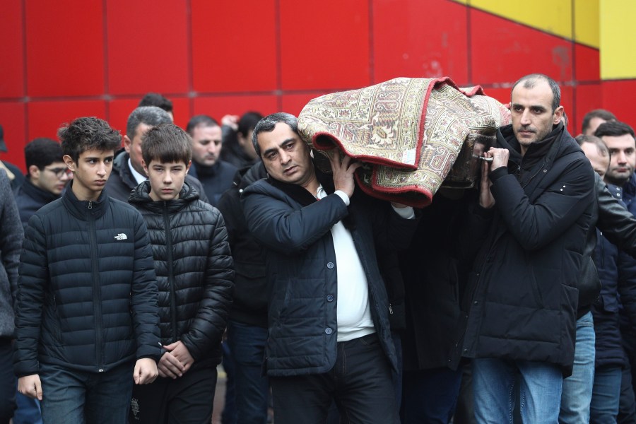 People attend a funeral of Mahammadali Eganov who died in the Azerbaijan Airlines Embraer 190 crash near the Kazakhstan's airport of Aktau at the age of 13, in Baku, Azerbaijan, Saturday, Dec. 28, 2024. (AP Photo)