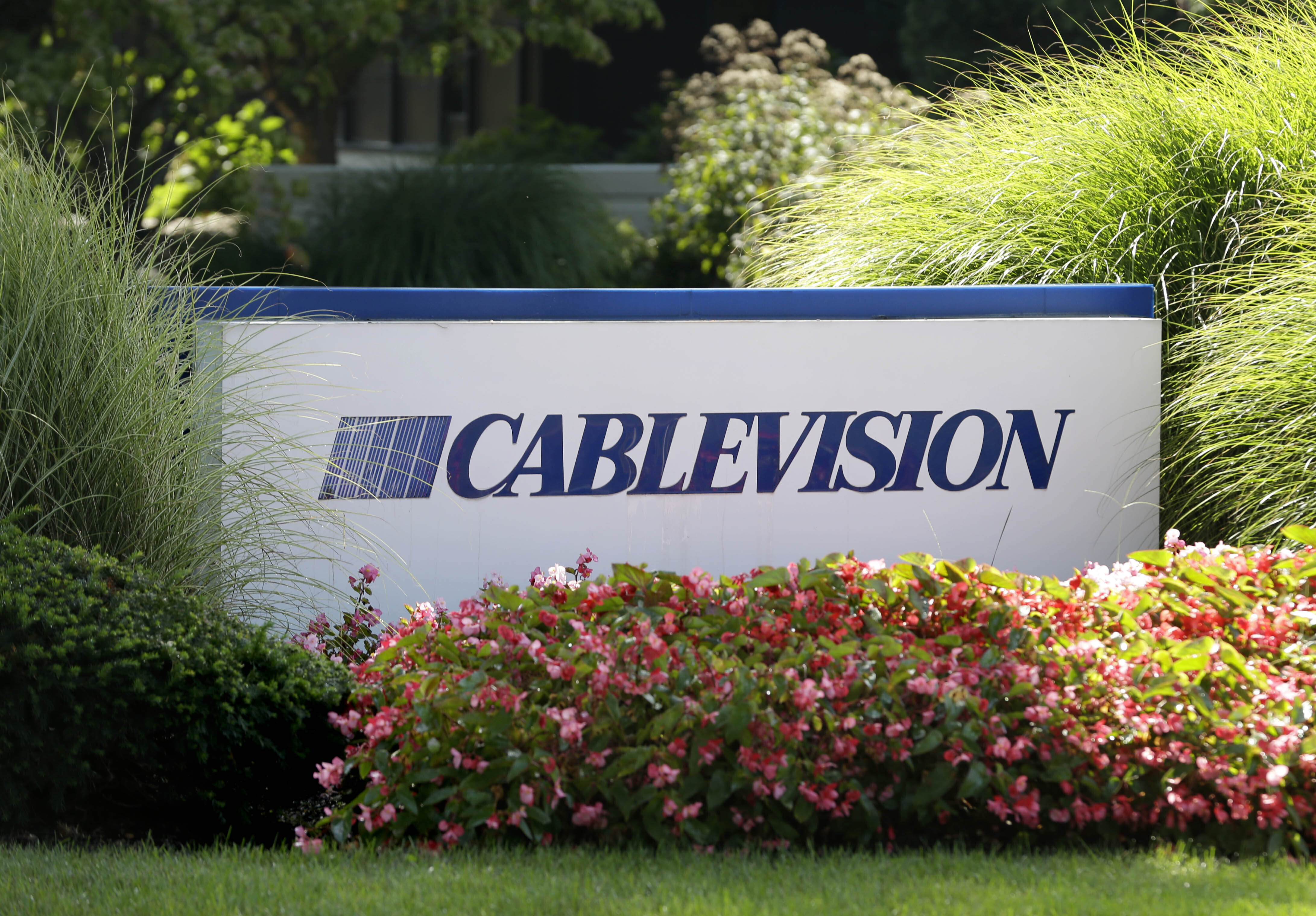 FILE - A sign is displayed at Cablevision headquarters in Bethpage, N.Y., on Sept. 17, 2015. (AP Photo/Seth Wenig, File)