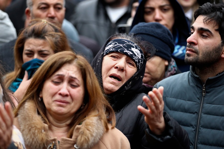 People mourn during a funeral of the crew members of the Azerbaijan Airlines Embraer 190 killed in a deadly plane crash in Kazakhstan this week, at the II Alley of Honor in Baku, Azerbaijan, Sunday, Dec. 29, 2024. (AP photo)