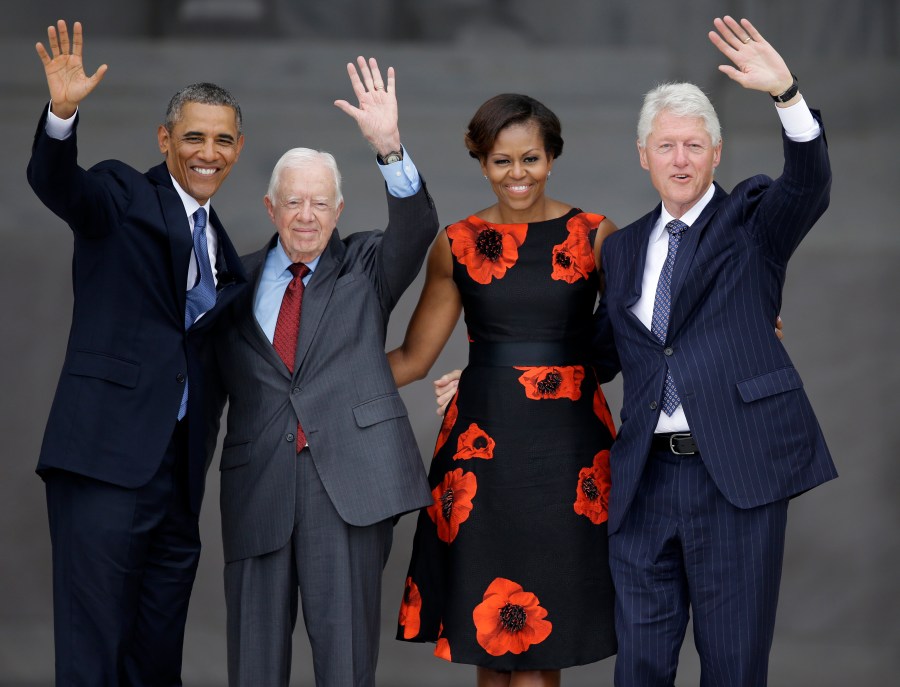 FILE - From left, President Barack Obama, former President Jimmy Carter, first lady Michelle Obama and former President Bill Clinton wave to the crowd from the steps of the Lincoln Memorial in Washington at the conclusion of a ceremony to commemorate the 50th anniversary of the 1963 March on Washington for Jobs and Freedom, Aug. 28, 2013. (AP Photo/Carolyn Kaster, File)