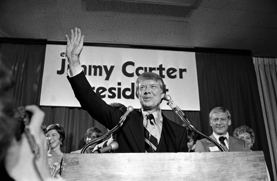 FILE - Georgia Gov. Jimmy Carter waves to a crowd gathered in Atlanta, Dec. 12, 1974, where he announced that he is a Democratic candidate for the presidency. Carter promised to "restore integrity, confidence and businesslike management to the federal government." (AP Photo, File)