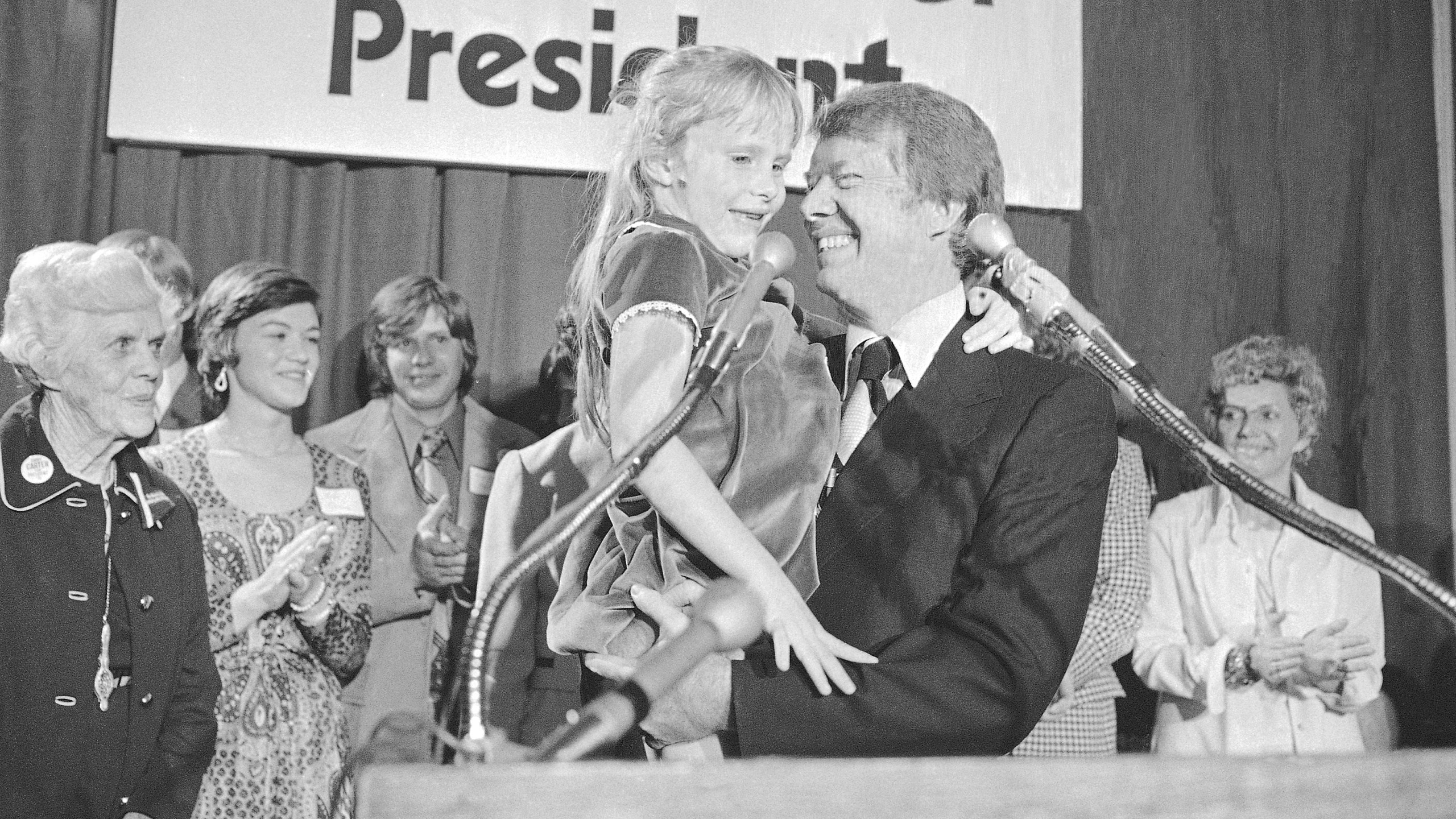 FILE - Georgia Gov. Jimmy Carter holds his daughter, Amy, just after he made his official announcement that he would seek the Democratic nomination for presidency on Dec. 13, 1974, in Atlanta. (AP Photo, File)