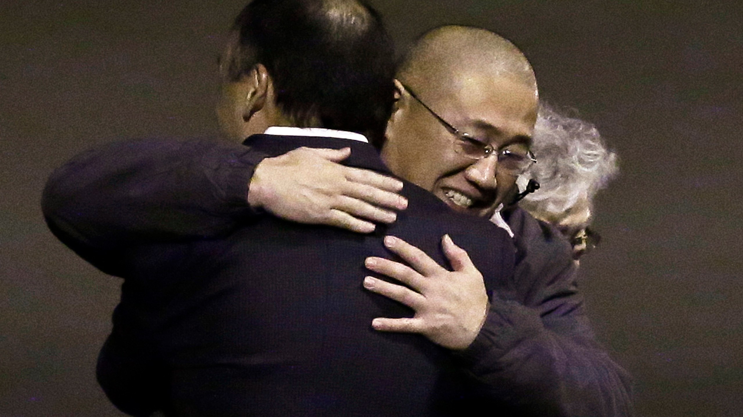 FILE - Kenneth Bae, right, who had been held in North Korea since 2012, is hugged following his arrival at Joint Base Lewis-McChord, Wash., Nov. 8, 2014, after he and fellow American Matthew Miller were freed during a top-secret mission. (AP Photo/Ted S. Warren, File)