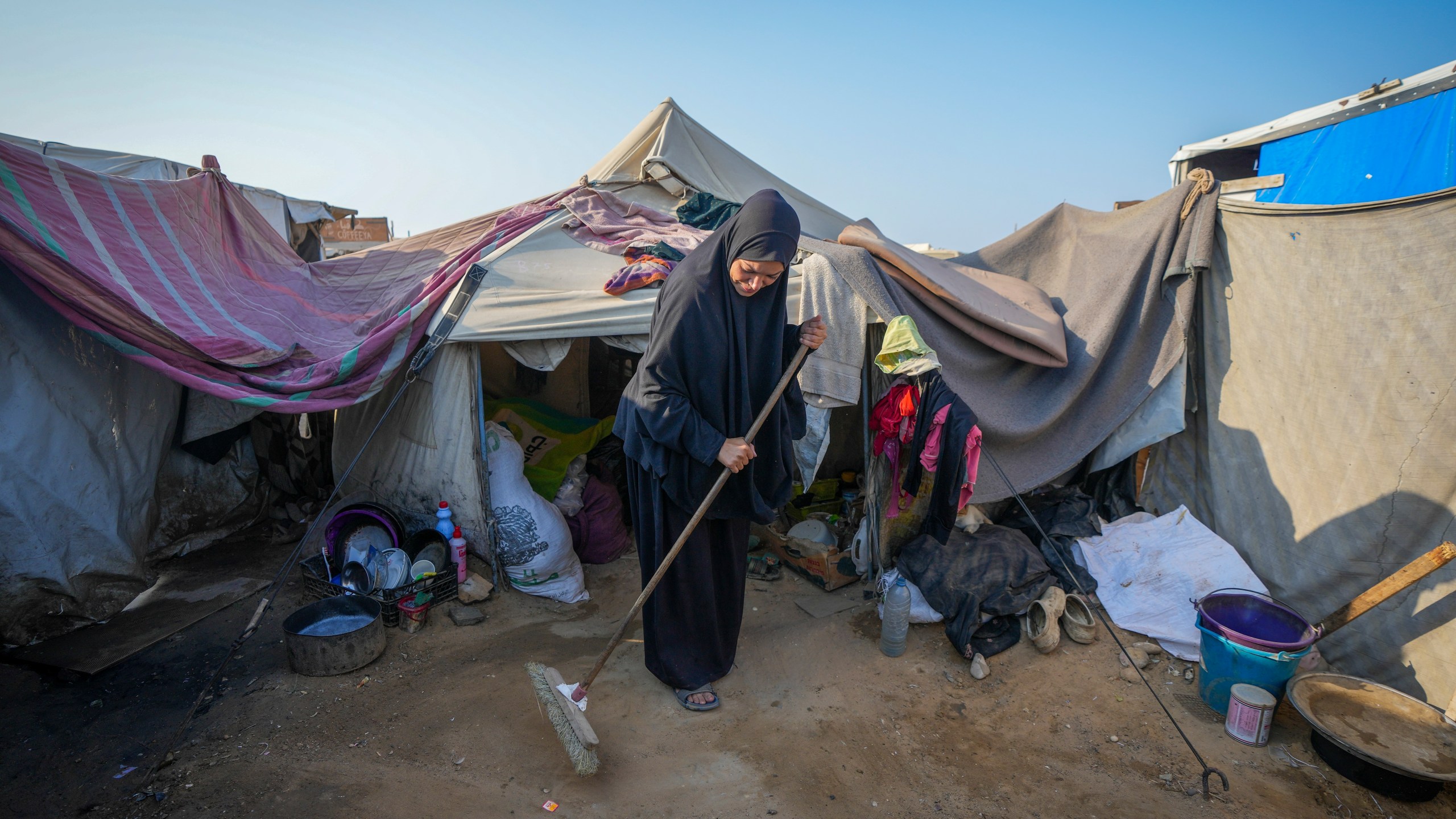 Alaa Hamami cleans outside her tent at a camp for displaced Palestinians in Deir al-Balah, Gaza Strip, Nov. 7, 2024. (AP Photo/Abdel Kareem Hana)