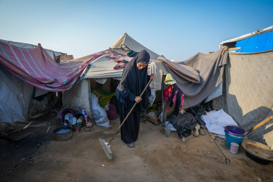 Alaa Hamami cleans outside her tent at a camp for displaced Palestinians in Deir al-Balah, Gaza Strip, Nov. 7, 2024. (AP Photo/Abdel Kareem Hana)