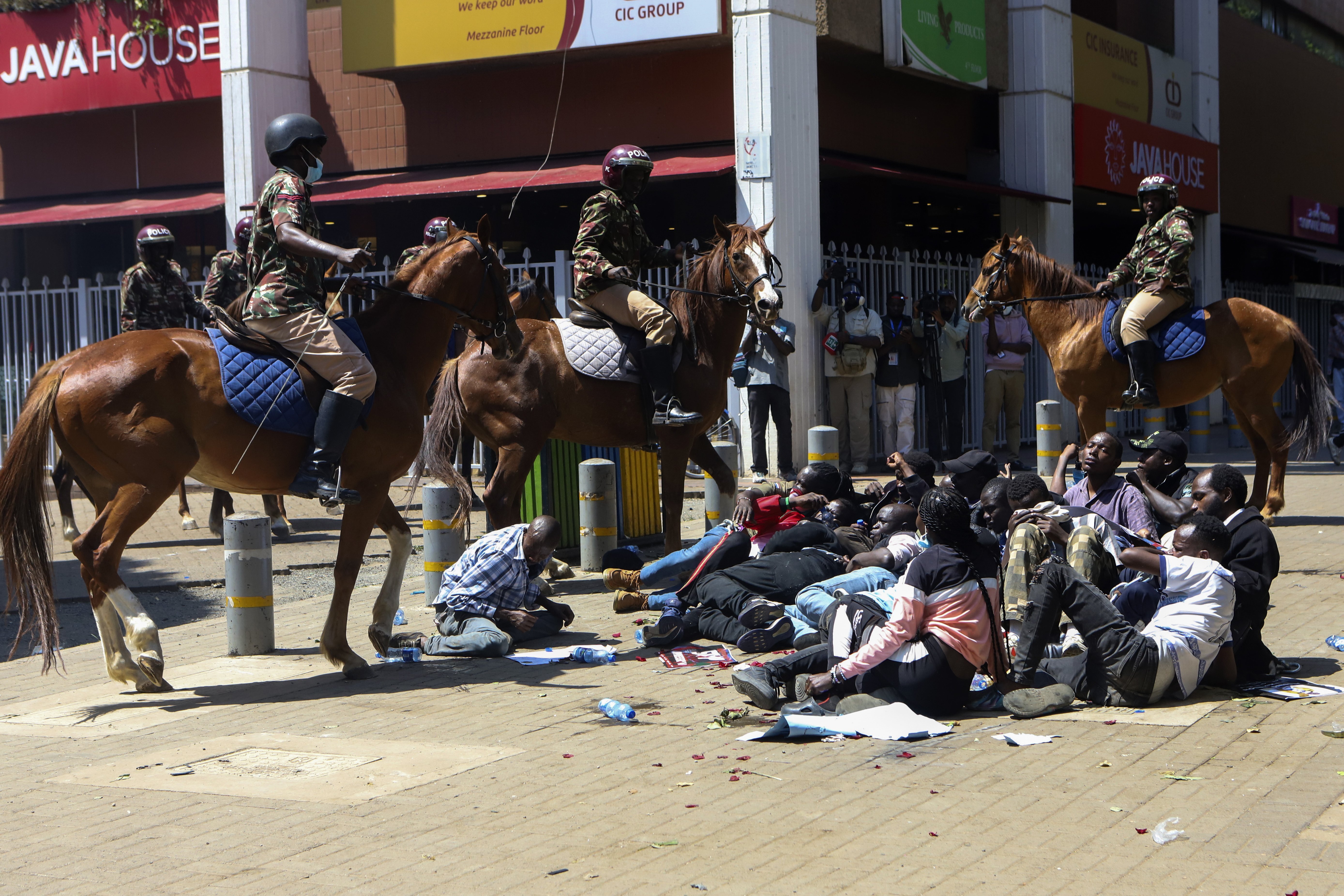 Police on horses surround protesters during protests against abductions in Nairobi, Kenya, Monday, Dec. 30, 2024. AP Photo/Andrew Kasuku)