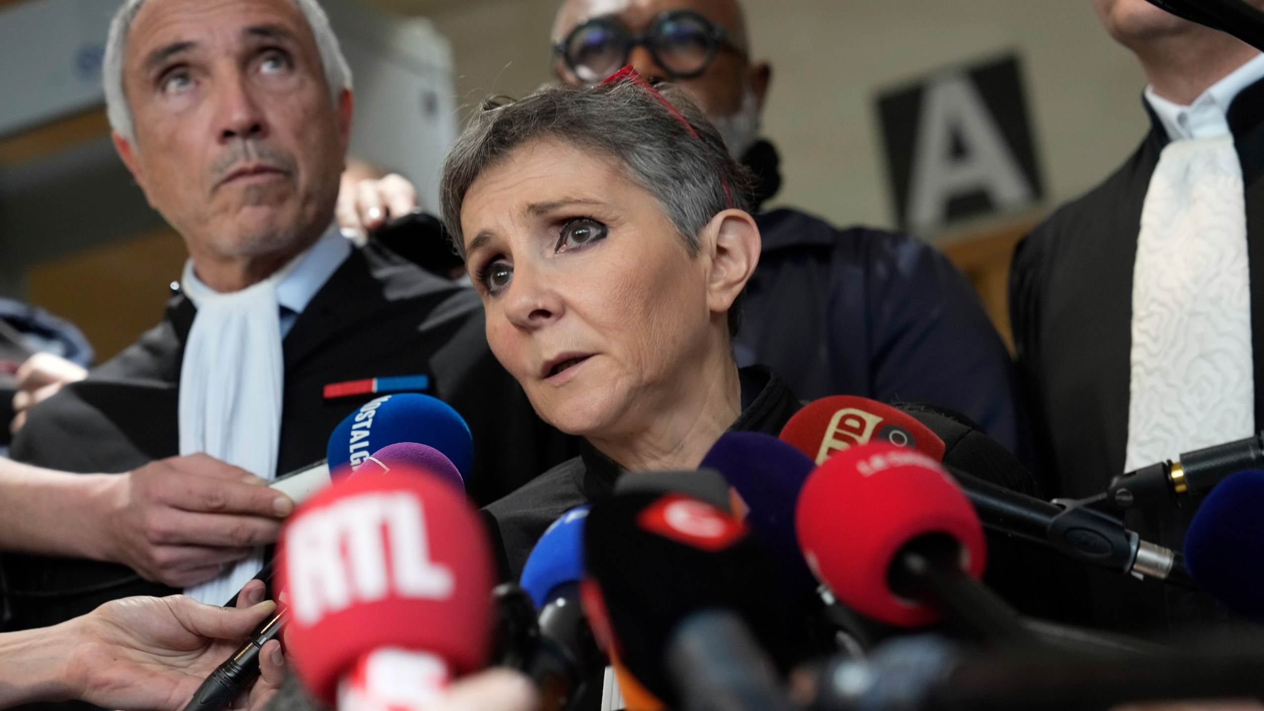 FILE - Lawyer Beatrice Zavarro talks to the media in the Avignon courthouse, southern France, Thursday, Dec. 19, 2024. (AP Photo/Lewis Joly, File)