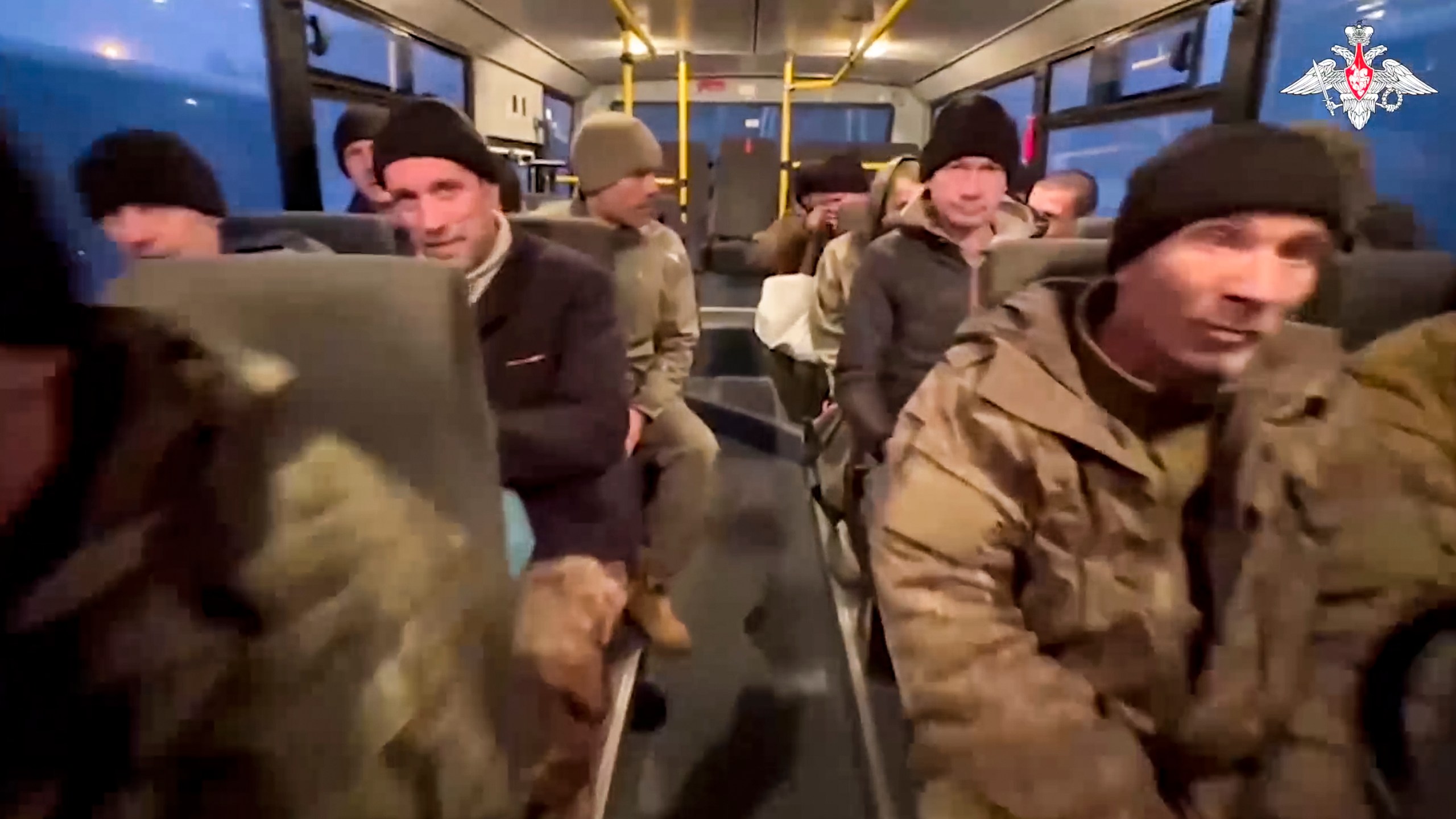 In this photo taken from video released by the Russian Defense Ministry Press Service on Monday, Dec. 30, 2024, a group of Russian soldiers sit in a bus after being released in a prisoners swap between Russia and Ukraine, at an unspecified location in Belarus. (Russian Defense Ministry Press Service via AP)