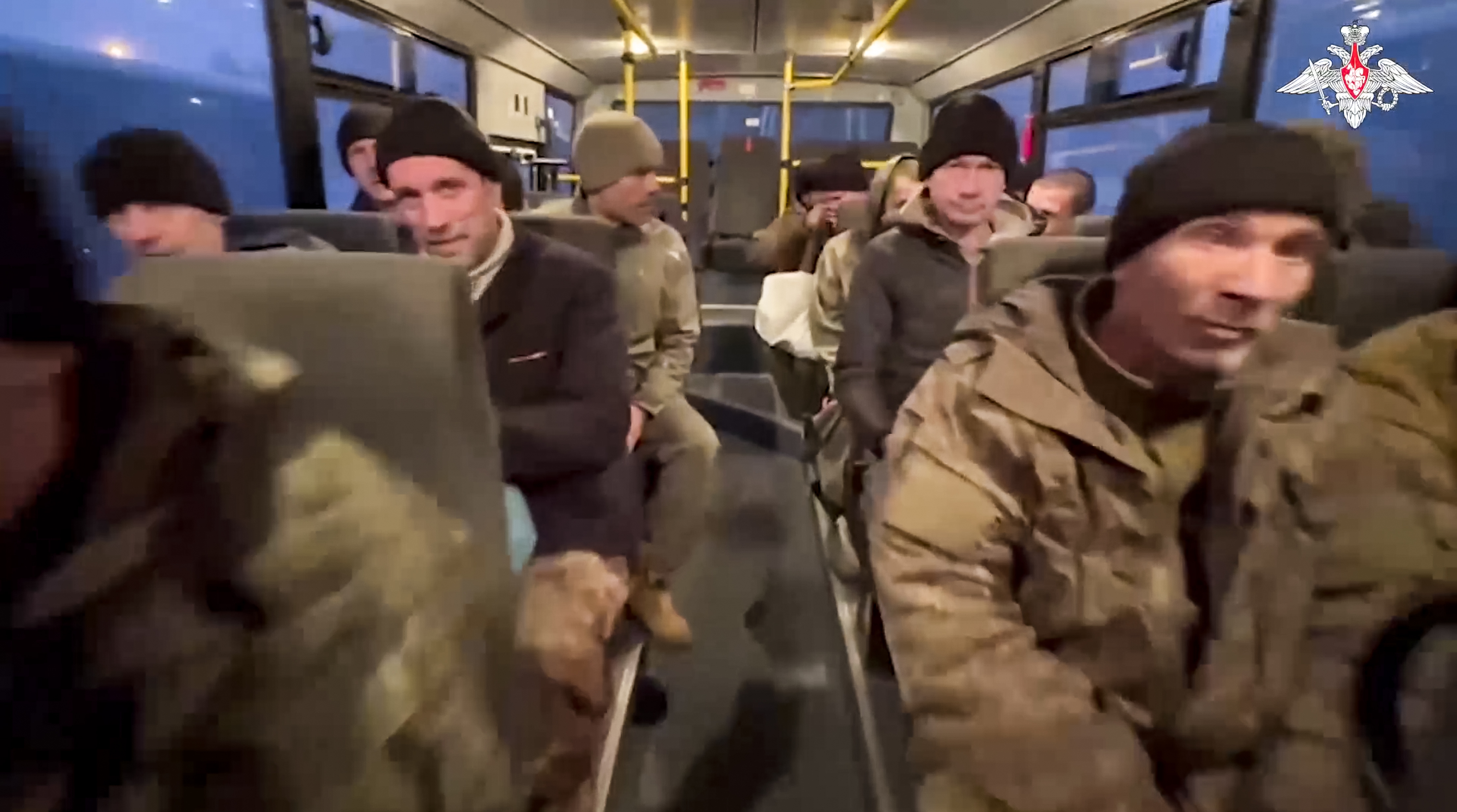 In this photo taken from video released by the Russian Defense Ministry Press Service on Monday, Dec. 30, 2024, a group of Russian soldiers sit in a bus after being released in a prisoners swap between Russia and Ukraine, at an unspecified location in Belarus. (Russian Defense Ministry Press Service via AP)