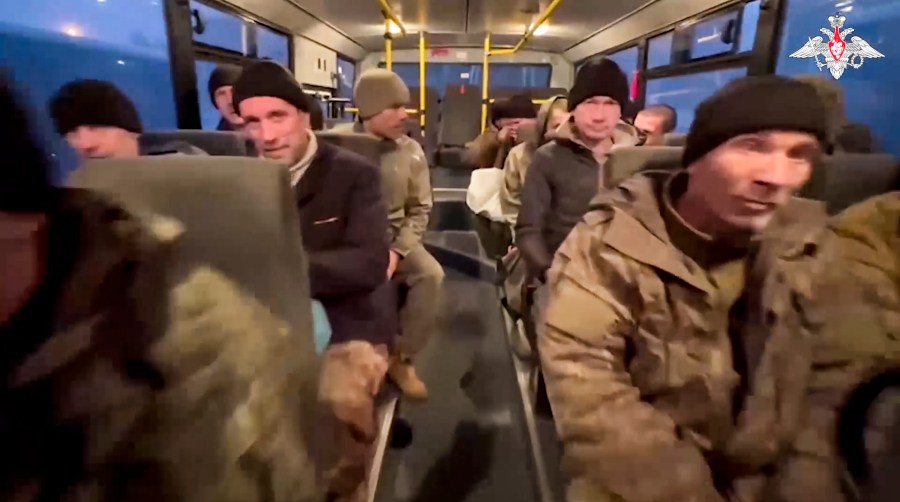 In this photo taken from video released by the Russian Defense Ministry Press Service on Monday, Dec. 30, 2024, a group of Russian soldiers sit in a bus after being released in a prisoners swap between Russia and Ukraine, at an unspecified location in Belarus. (Russian Defense Ministry Press Service via AP)