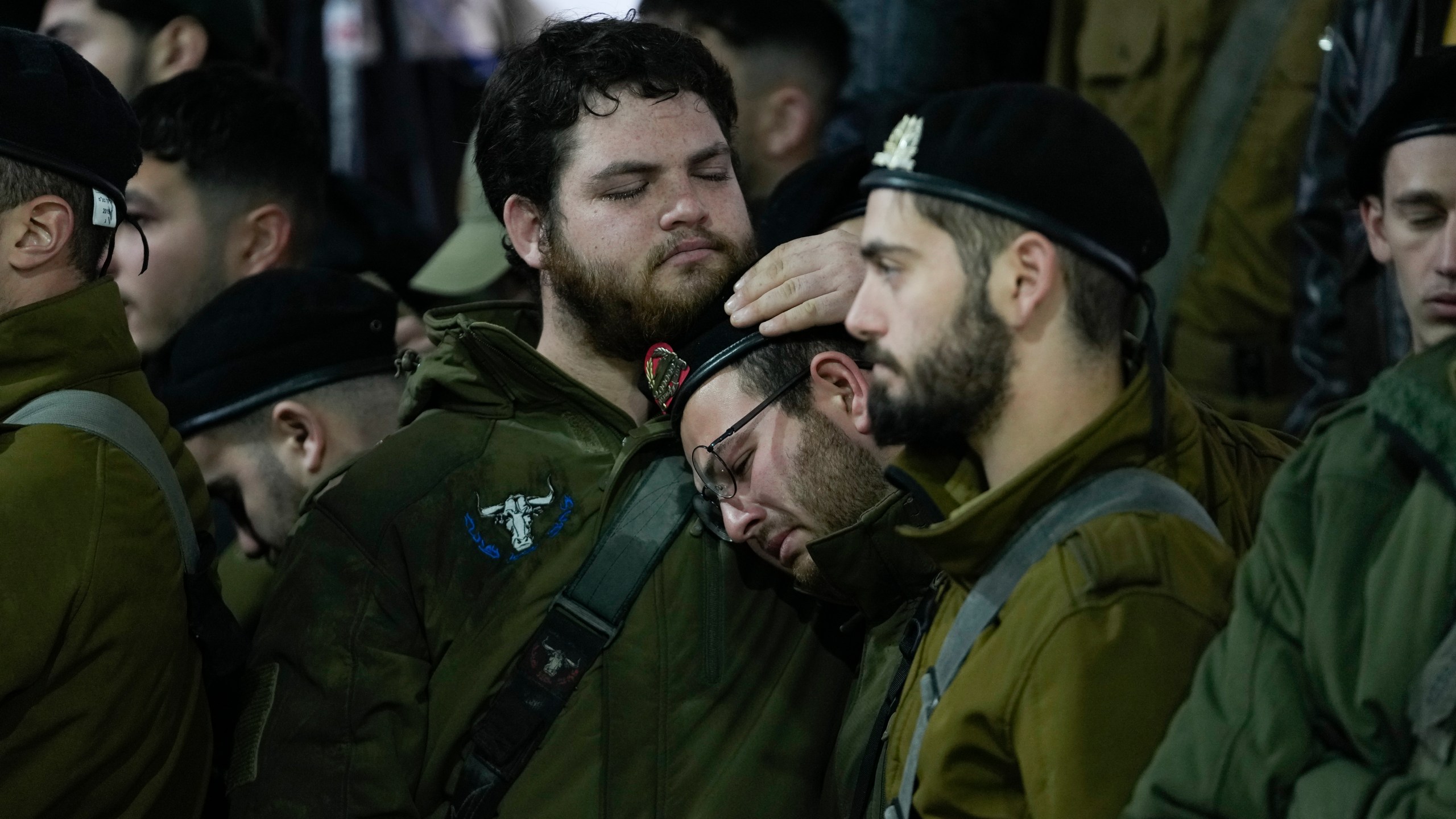 People attend the funeral of 1st Sgt. Yuval Shoham, who was killed in a combat in the Gaza Strip, at Mount Herzl military cemetery in Jerusalem, Monday, Dec. 30, 2024. (AP Photo/Matias Delacroix)