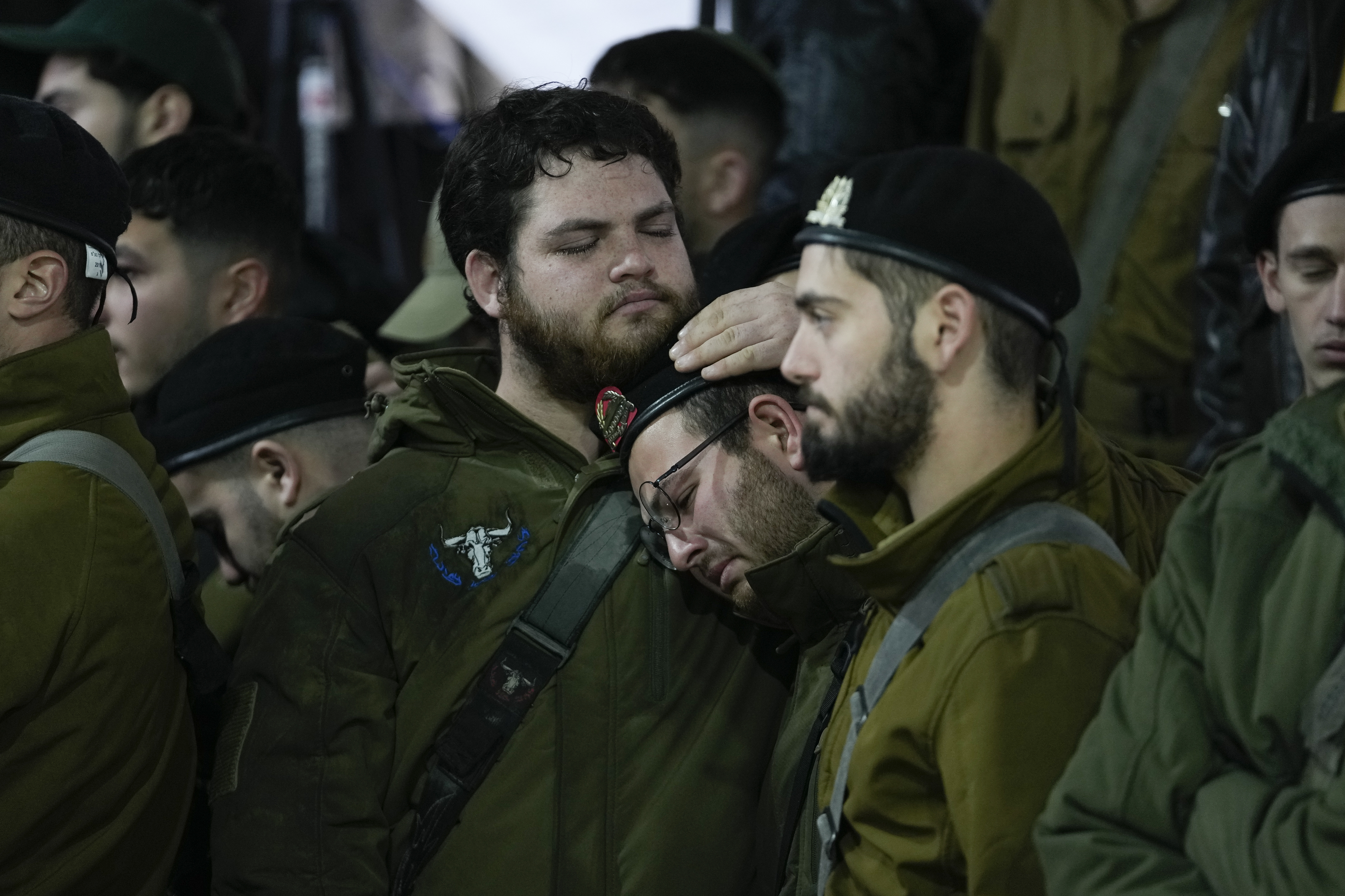 People attend the funeral of 1st Sgt. Yuval Shoham, who was killed in a combat in the Gaza Strip, at Mount Herzl military cemetery in Jerusalem, Monday, Dec. 30, 2024. (AP Photo/Matias Delacroix)