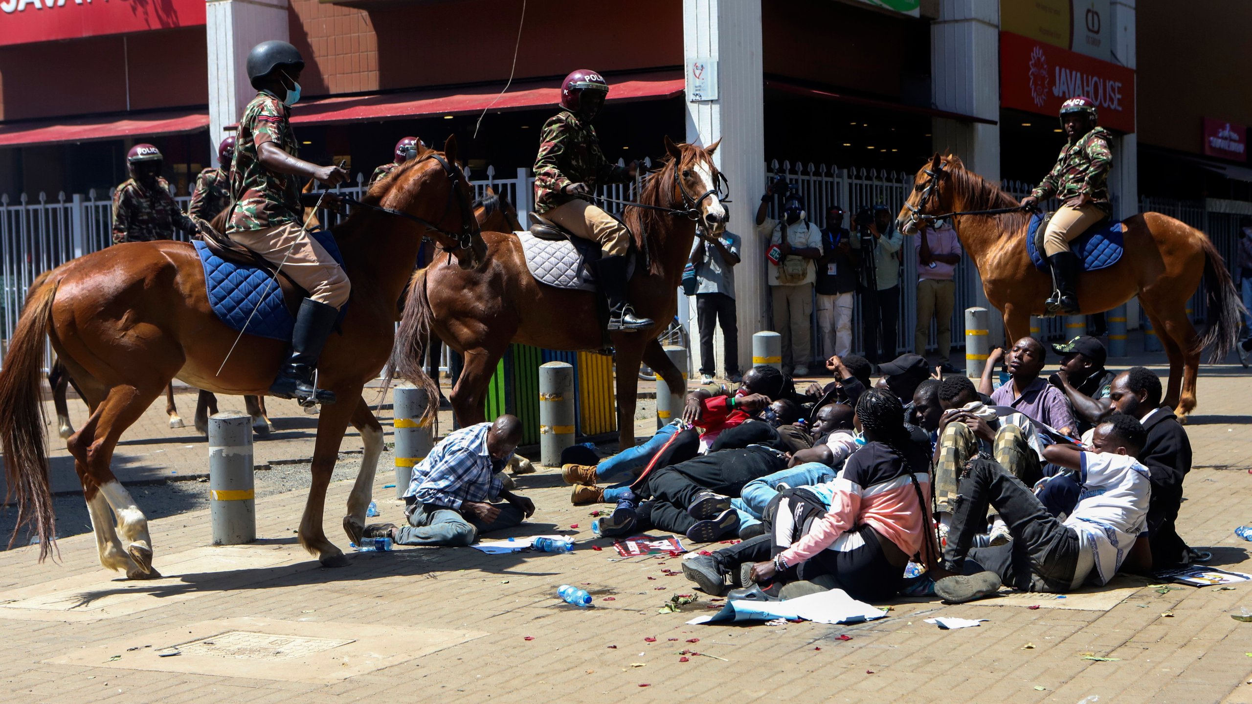 Police on horses surround protesters during protests against abductions in Nairobi, Kenya, Monday, Dec. 30, 2024. AP Photo/Andrew Kasuku)