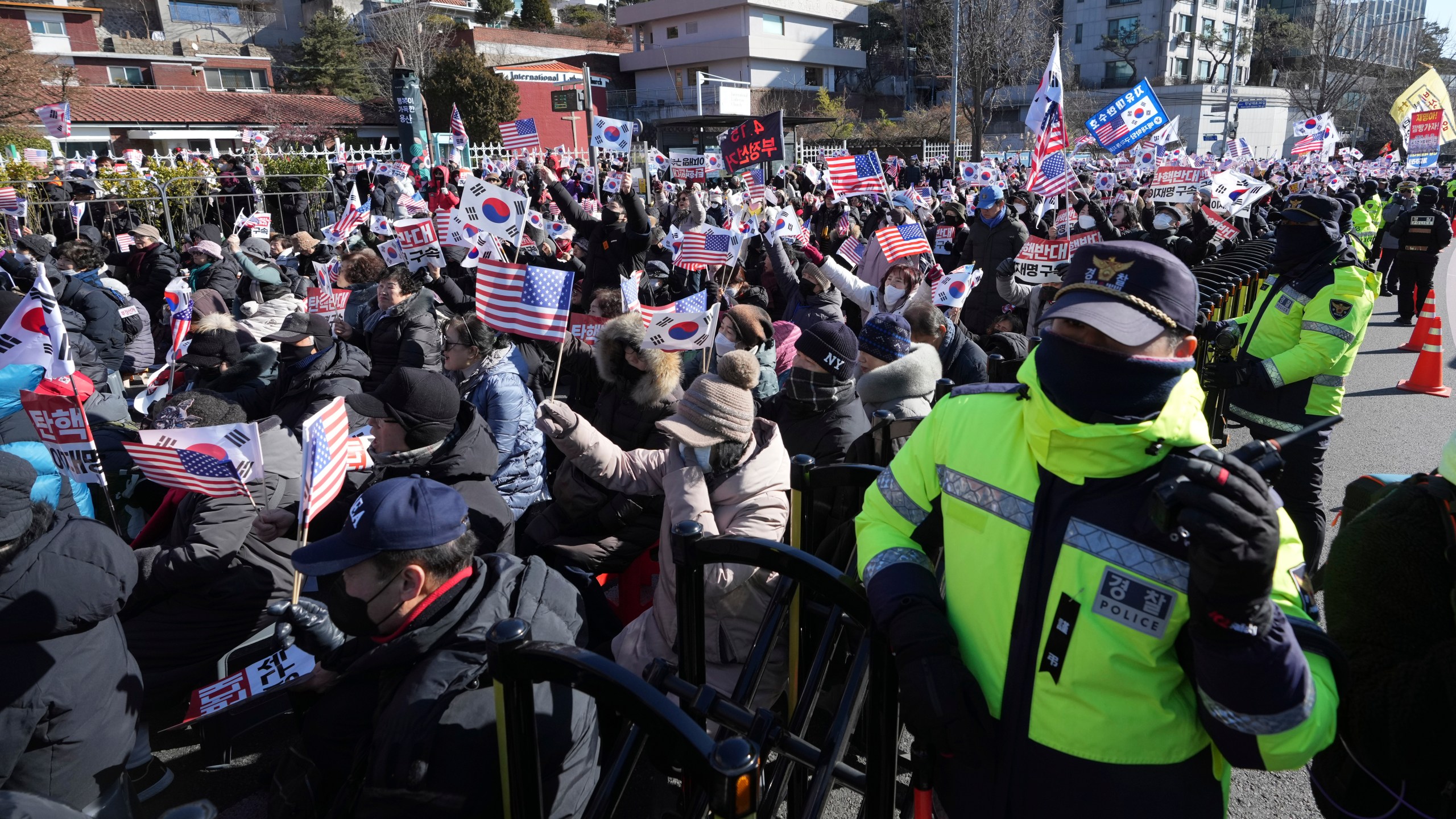 Supporters of impeached South Korean President Yoon Suk Yeol stage a rally after hearing a news that a court issued warrants to detain Yoon, near the presidential residence in Seoul, South Korea, Tuesday, Dec. 31, 2024. (AP Photo/Lee Jin-man)