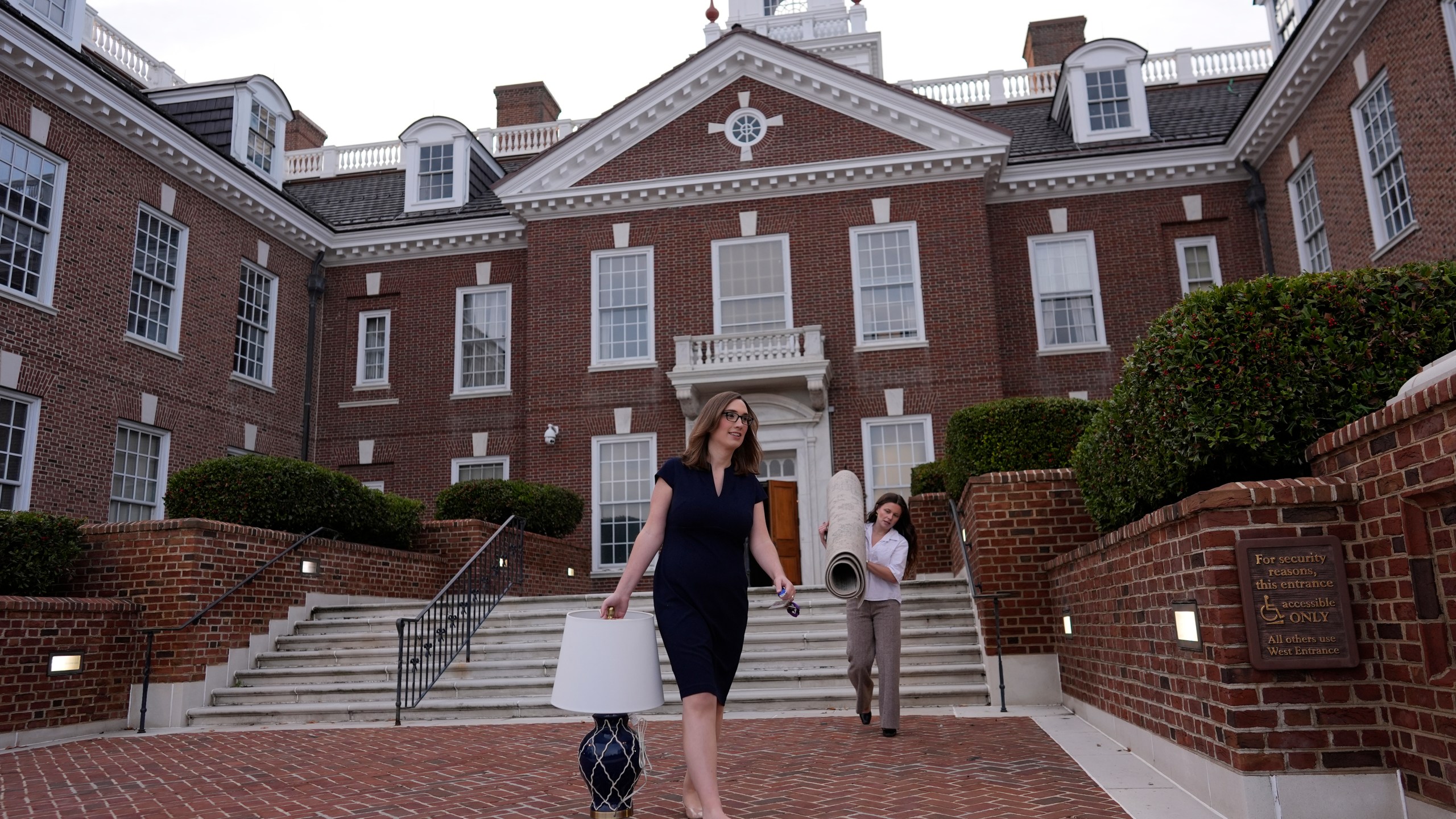 U.S.-Rep.-elect Sarah McBride, D-Del., left, and her incoming Deputy Chief of Staff & Communications Director, Michaela Kurinsky-Malos, move out of McBride's Delaware State Senate office at the Delaware Legislative Hall in Dover, Del., Tuesday, Dec. 17, 2024. (AP Photo/Carolyn Kaster)