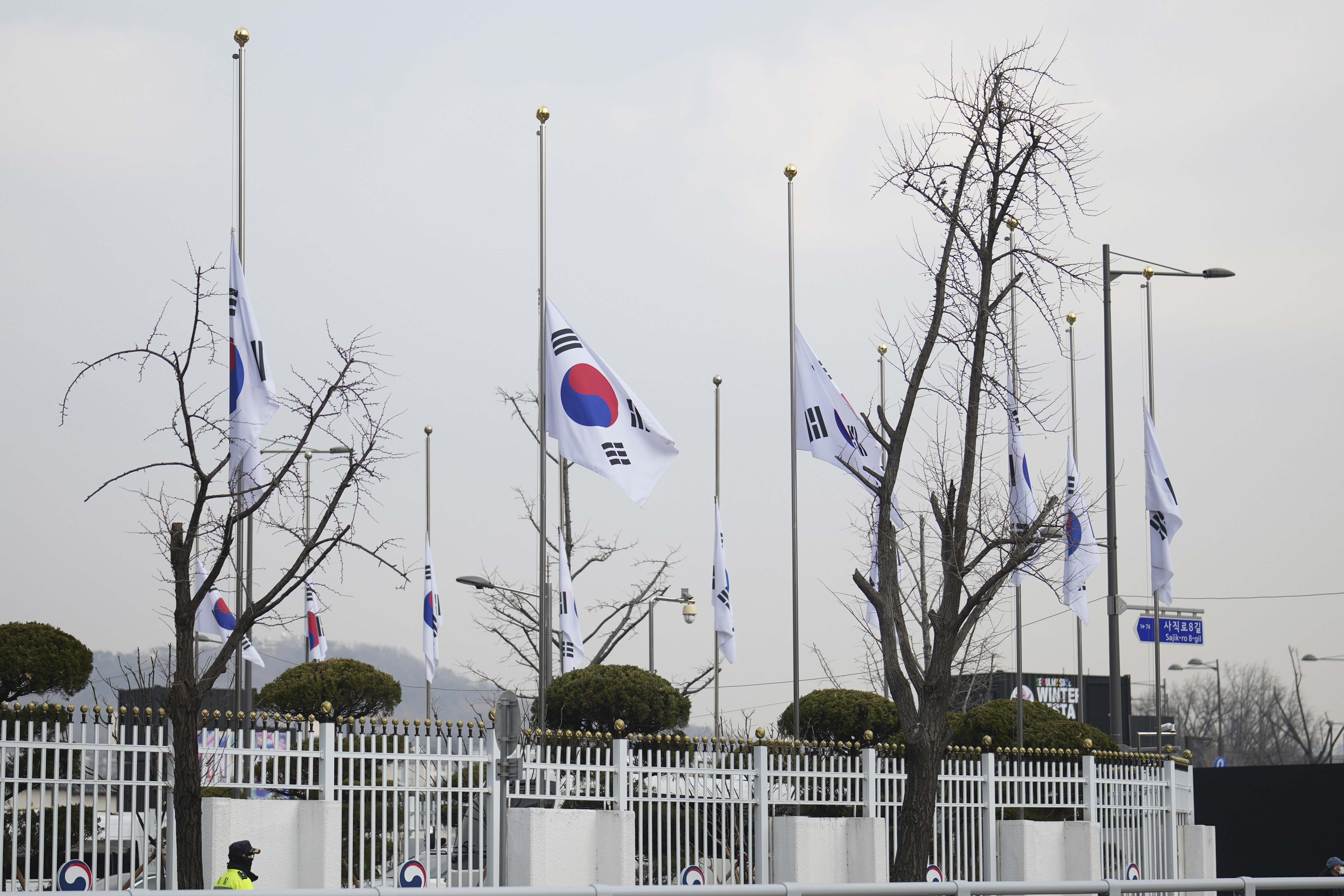 South Korean national flags fly at half-staff at a government complex in Seoul, South Korea, Monday, Dec. 30, 2024, a day after a jetliner skidded off a runway, slammed into a concrete fence and burst into flames at an airport the town of Muan. (AP Photo/Lee Jin-man)