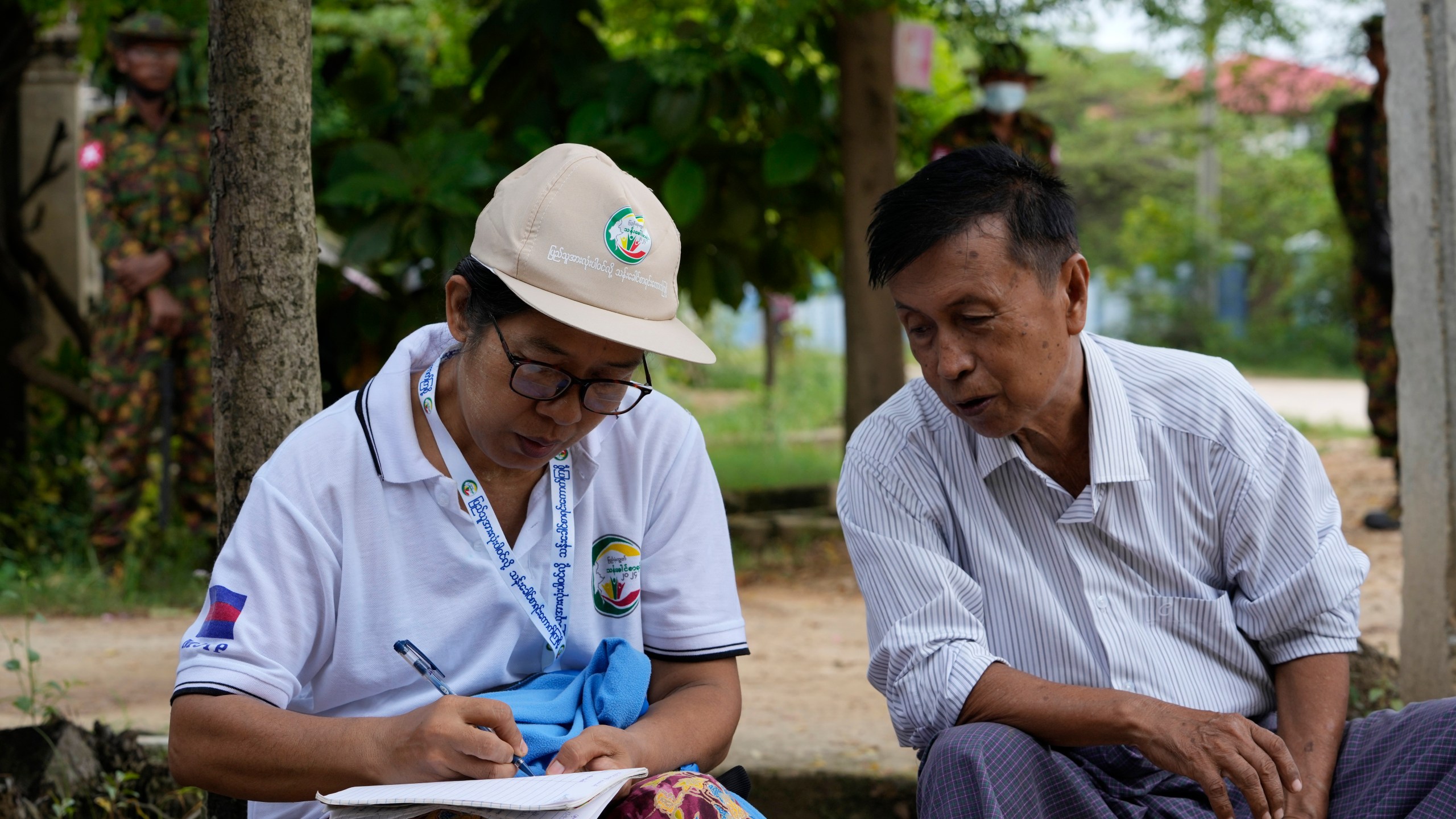 FILE - A census enumerator, left, asks questions to a man in Naypyitaw, Myanmar Tuesday, Oct. 1, 2024 as the country holds a national census to compile voter lists for a general election and to analyze population and socioeconomic trends. (AP Photo/Aung Shine Oo, File)