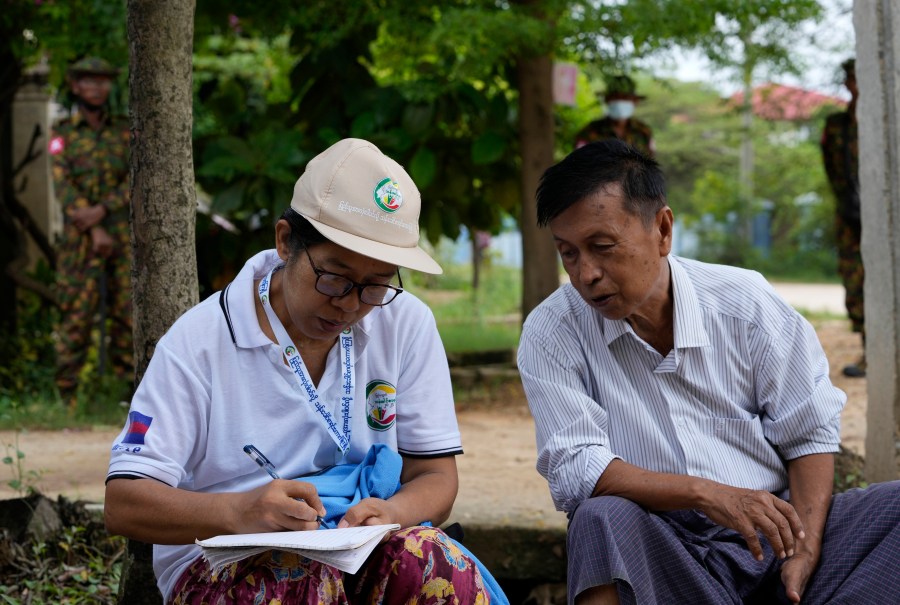 FILE - A census enumerator, left, asks questions to a man in Naypyitaw, Myanmar Tuesday, Oct. 1, 2024 as the country holds a national census to compile voter lists for a general election and to analyze population and socioeconomic trends. (AP Photo/Aung Shine Oo, File)