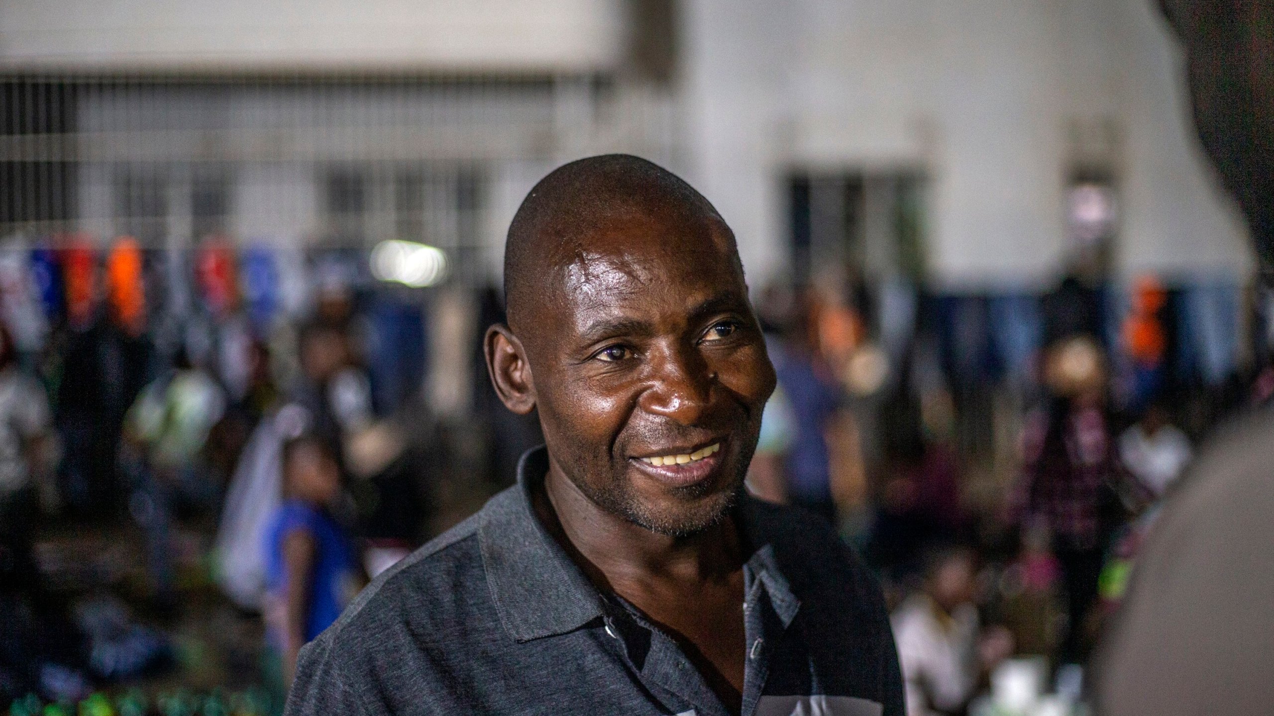 Oswald Gwari, a vendor at an informal and illegal market smiles in central Harare, Zimbabwe, Friday, Nov. 11, 2024. (AP Photo/Aaron Ufumeli)