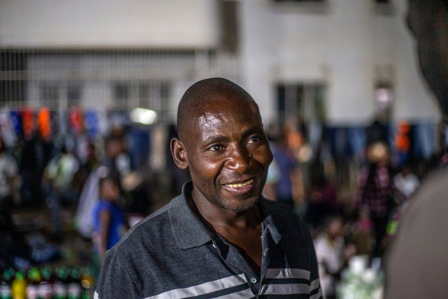 Oswald Gwari, a vendor at an informal and illegal market smiles in central Harare, Zimbabwe, Friday, Nov. 11, 2024. (AP Photo/Aaron Ufumeli)