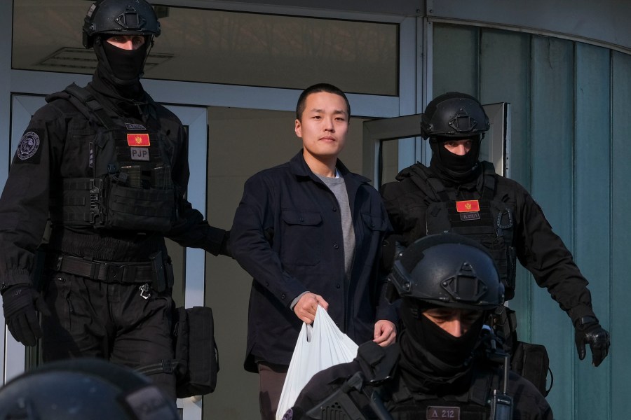 FILE - Montenegrin police officers escort South Korean citizen, Terraform Labs founder Do Kwon in Montenegro's capital Podgorica, Saturday, March 23, 2024. (AP Photo/Risto Bozovic, File)