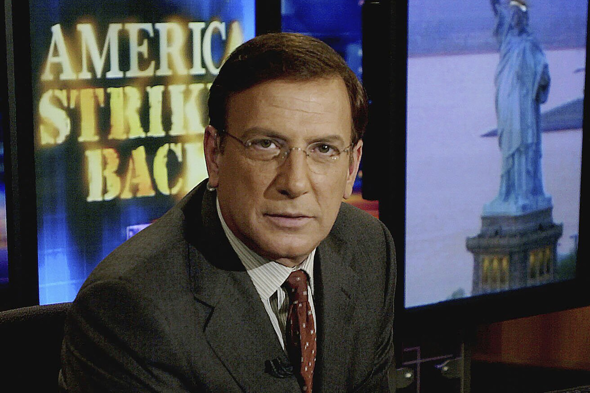 FILE- CNN news anchor Aaron Brown poses in the network's New York studios in this Oct. 18, 2001 file photo. (AP Photo/Gino Domenico, File)