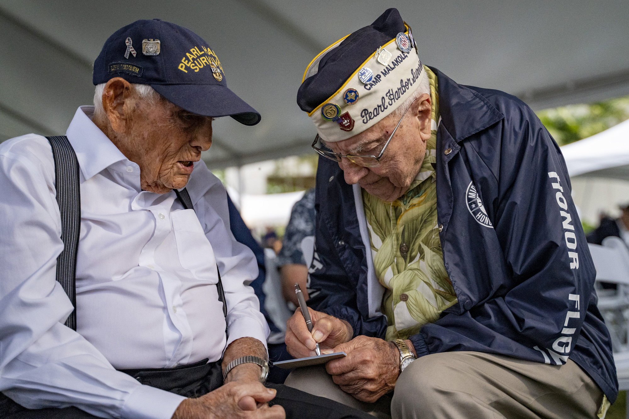 FILE - Pearl Harbor survivors Harry Chandler, 102, left, and Herb Elfring, 101, talk during the 82nd Pearl Harbor Remembrance Day ceremony on Dec. 7, 2023, at Pearl Harbor in Honolulu. (AP Photo/Mengshin Lin, File)