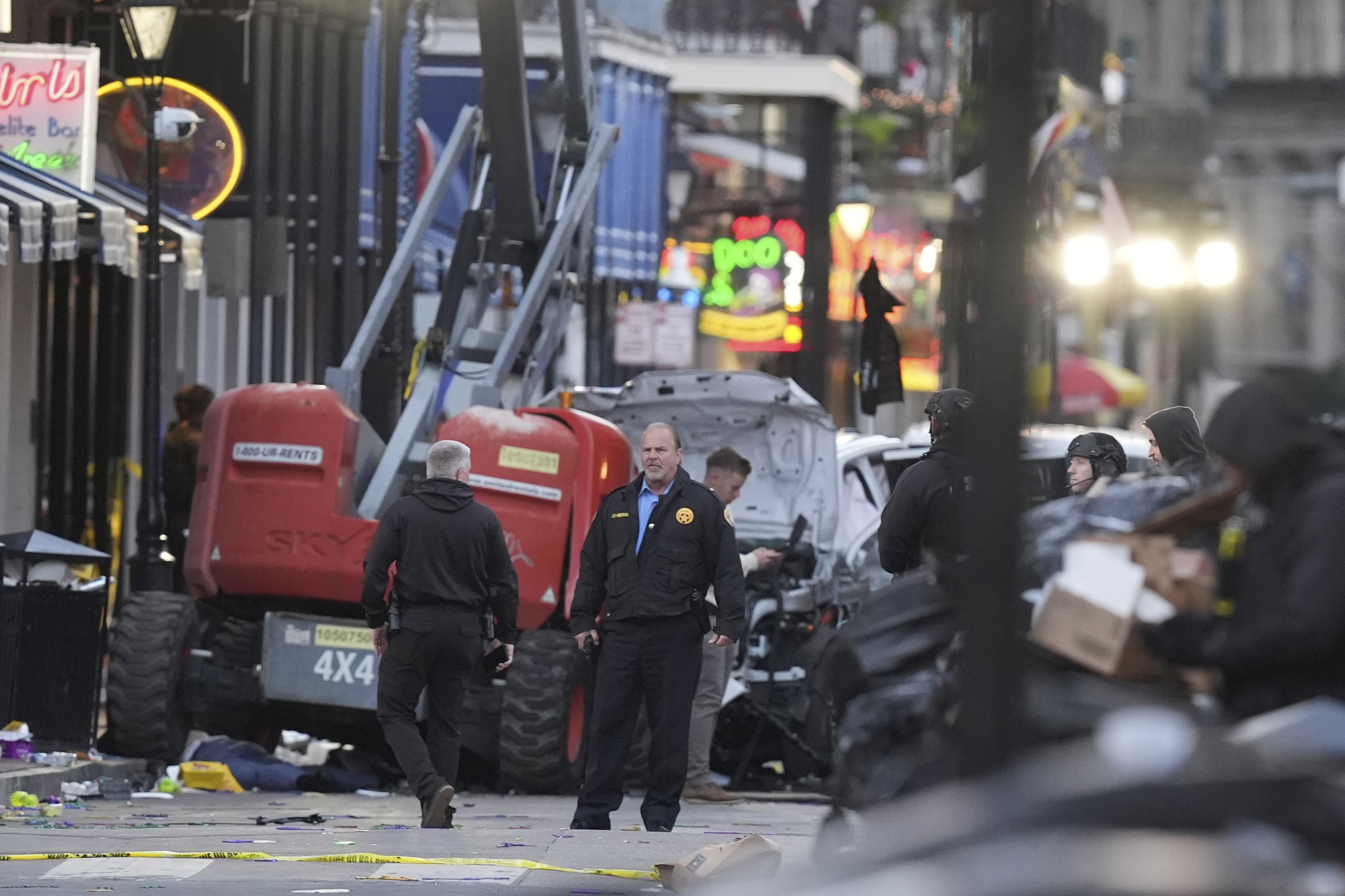 EDS NOTE: GRAPHIC CONTENT - Security personnel investigate the scene on Bourbon Street after a vehicle drove into a crowd on New Orleans' Canal and Bourbon Street, Wednesday Jan. 1, 2025. (AP Photo/Gerald Herbert)