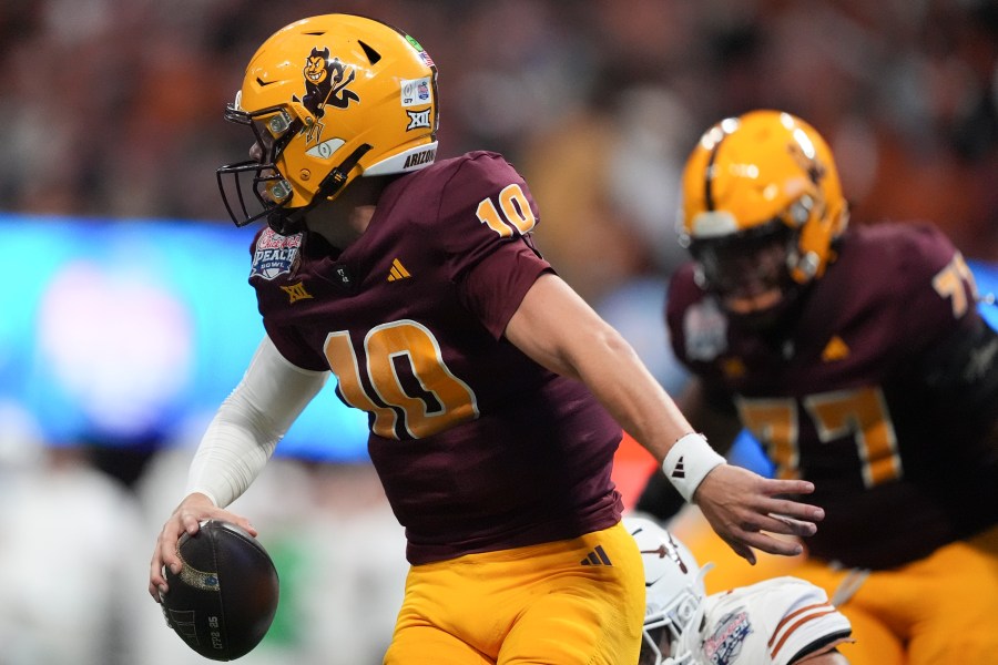 Arizona State quarterback Sam Leavitt (10) runs out of the pocket against Texas during the first half in the quarterfinals of a College Football Playoff, Wednesday, Jan. 1, 2025, in Atlanta. (AP Photo/Brynn Anderson)